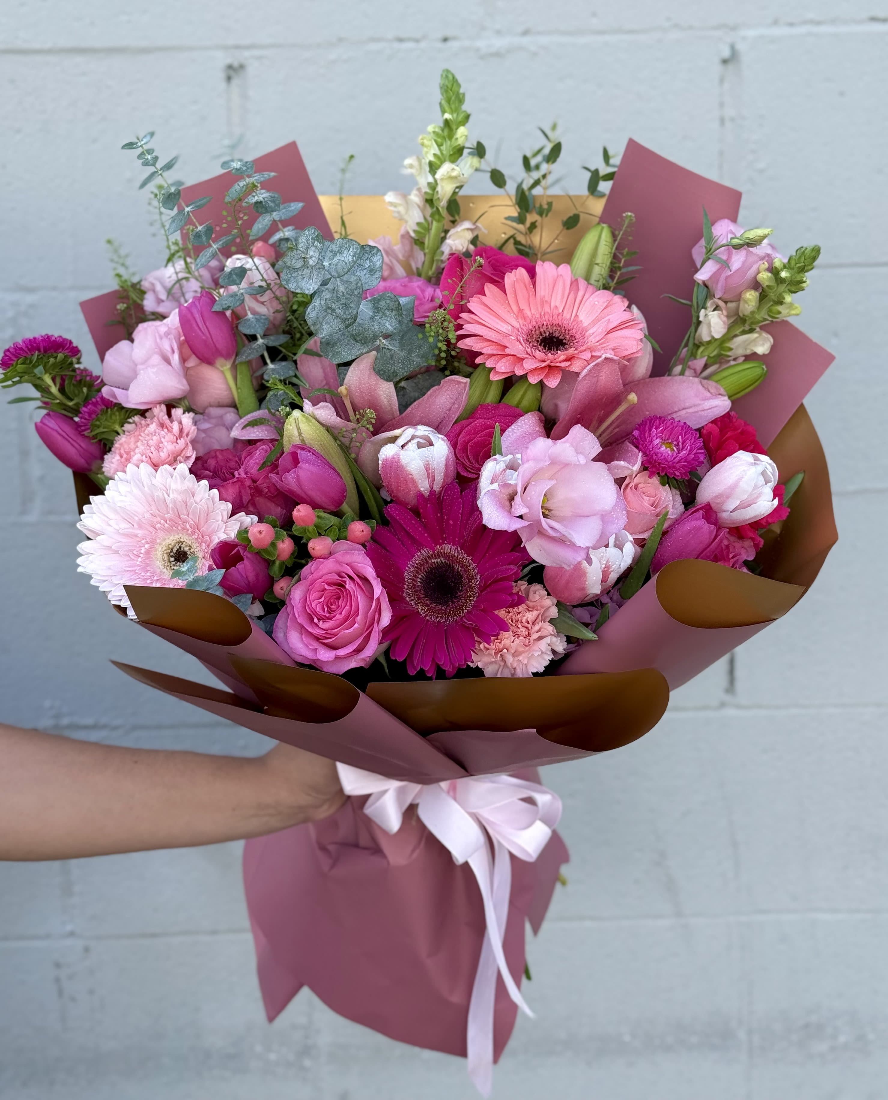 Pink mixed bouquet with gerbera daisies, roses, tulips, and lilies