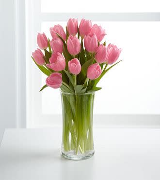 Pink tulips arranged in a clear glass vase