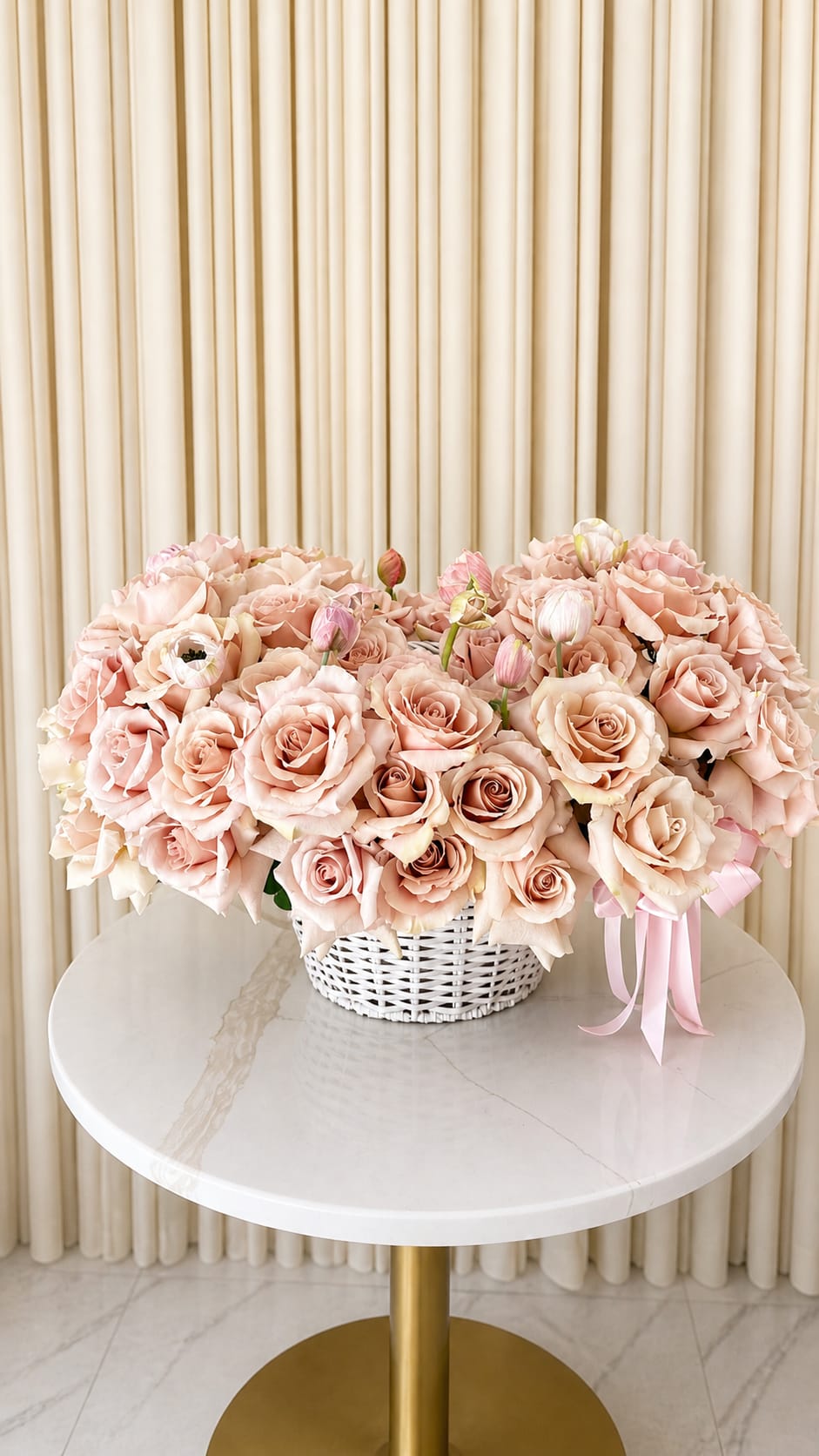 Blush And Blooms - Soft, refined, and effortlessly elegant, blush and blooms  is a lush composition of premium blush-toned roses paired with delicate seasonal blooms. Designed in a full, garden-inspired style, this arrangement features layers of soft petals and subtle texture, creating a natural sense of movement and depth.  The gentle blush palette brings a calm, romantic feel, while the classic basket base adds warmth and a timeless touch. Each bloom is thoughtfully placed to achieve a balanced, airy silhouette that feels both fresh and elevated.  Perfect for meaningful gifting, celebrations, or simply brightening a space, Blush And Blooms captures the beauty of simplicity with a luxurious finish.