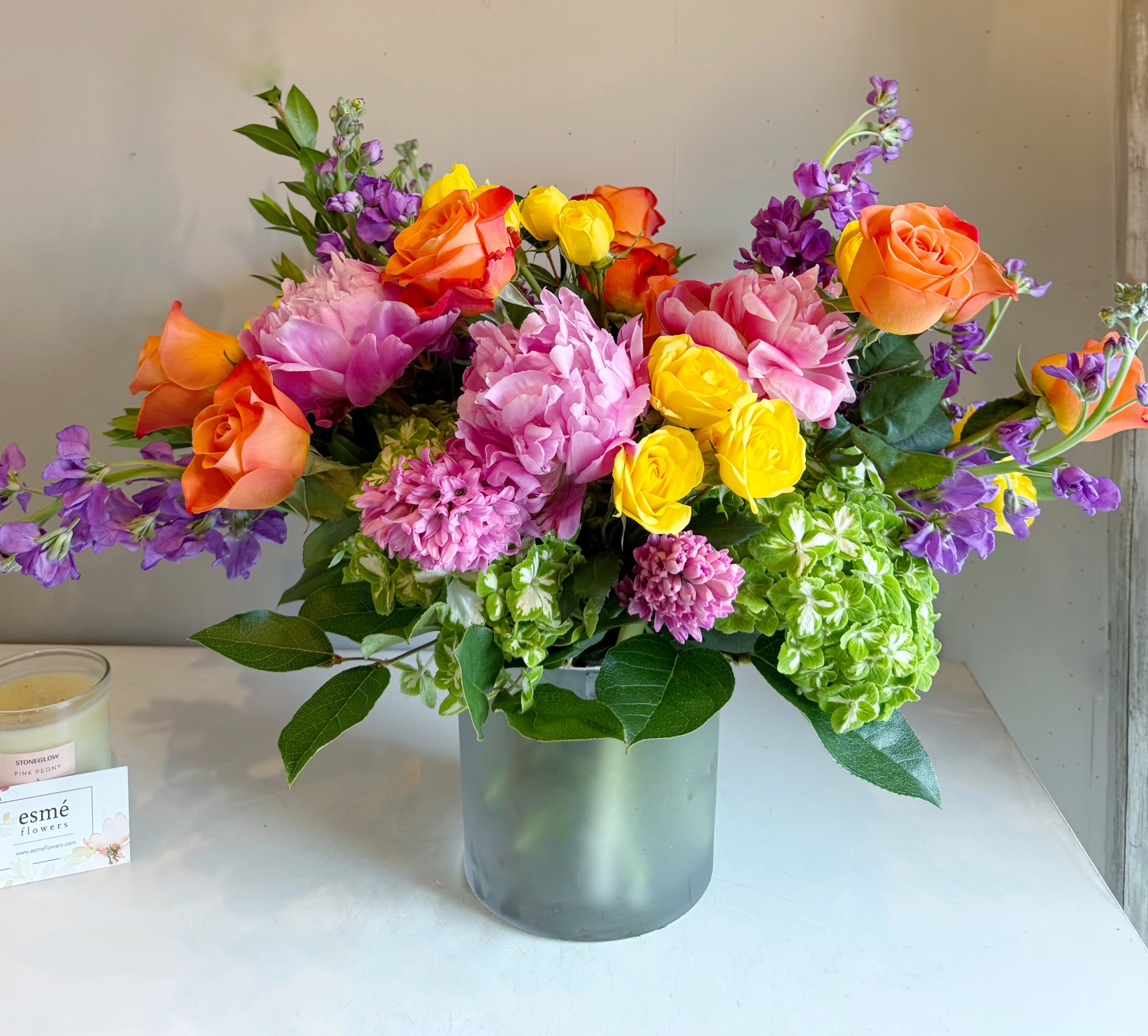 Sunlit Fiesta - A joyful celebration of the season, Sunlit Fiesta blends bright, sunlit blooms with a soft, elegant touch. Cheerful seasonal blooms come together to create this warm and graceful charm for any occasion.