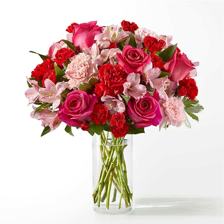 Pink and red mixed bouquet in a clear glass vase