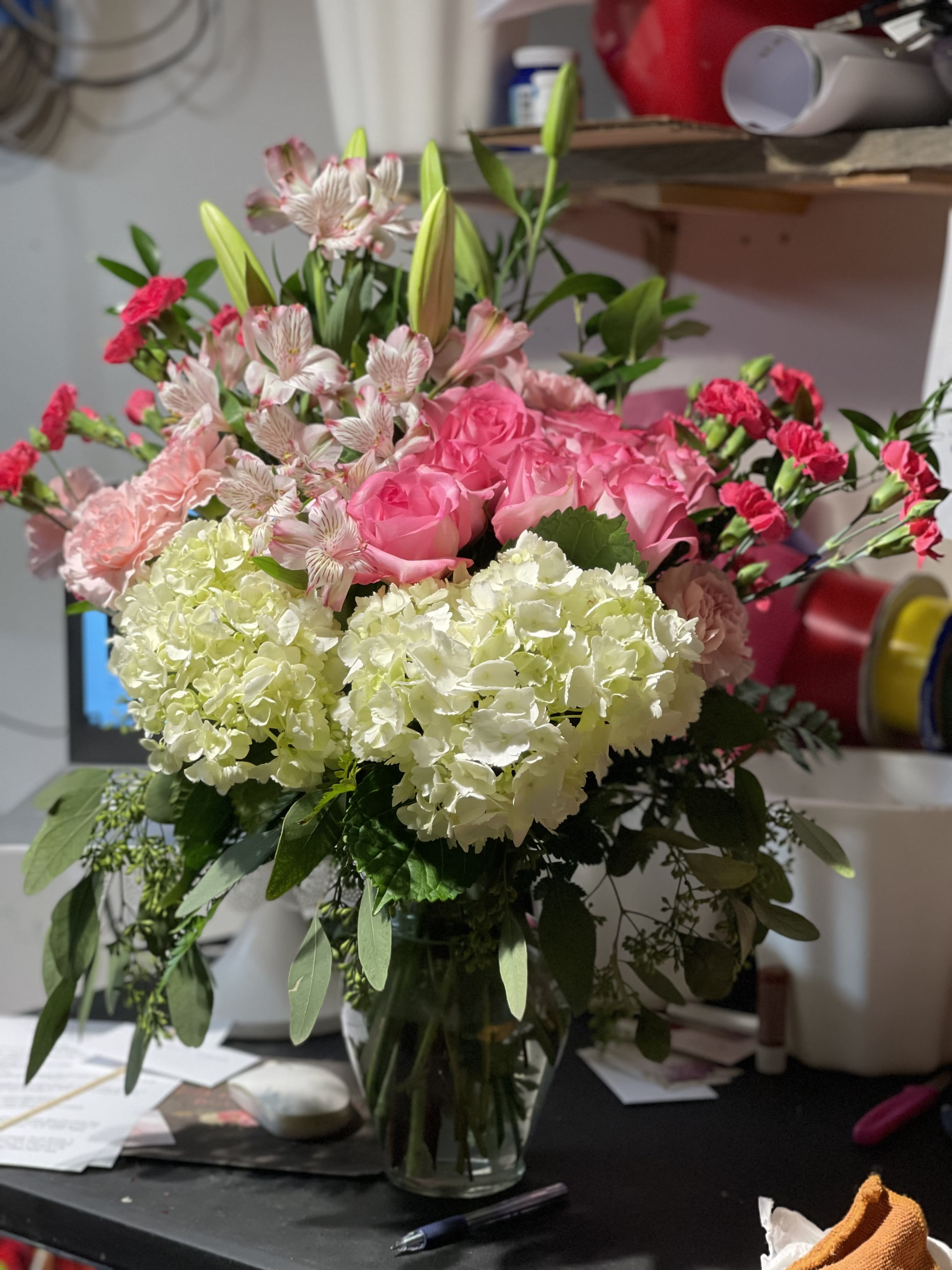 Pink roses and white hydrangeas arranged in a glass vase