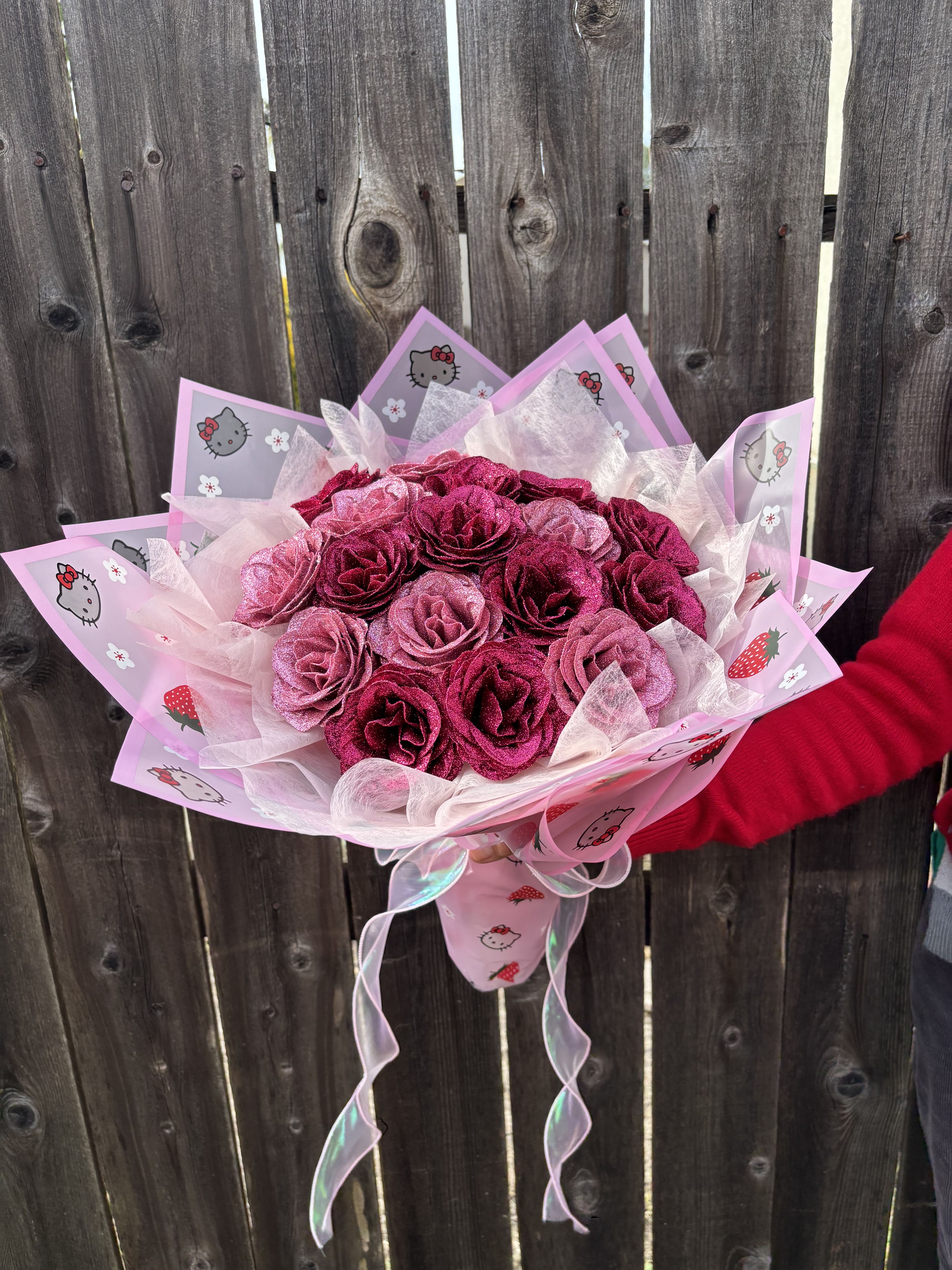Pink rose bouquet wrapped in Hello Kitty paper with ribbon
