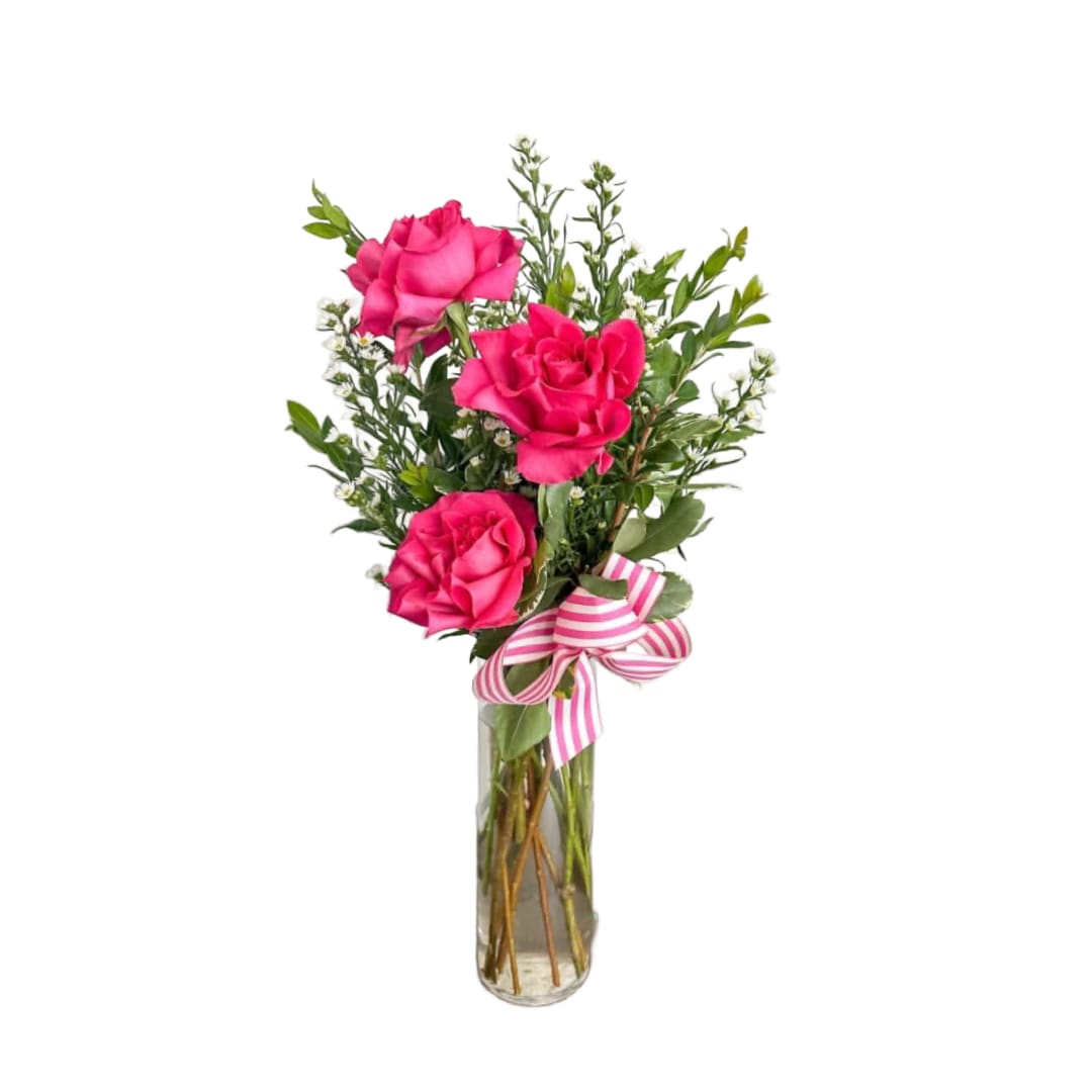 Sweetheart Rose Trio - Simple, sweet, and full of charm—Sweetheart Rose Trio features three vibrant pink roses accented with fresh greenery and delicate filler flowers, all arranged in a clear glass vase and finished with a classic striped bow. Perfect for a thoughtful gesture, a desk surprise, or a “just because” moment, this petite arrangement delivers beauty in the sweetest way. 