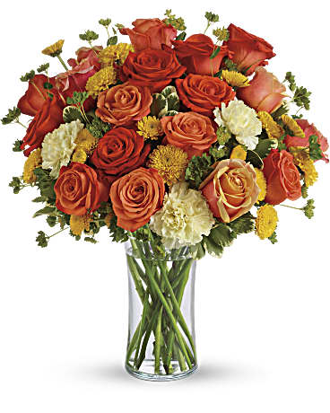 Bouquet of orange and red roses in a clear glass vase
