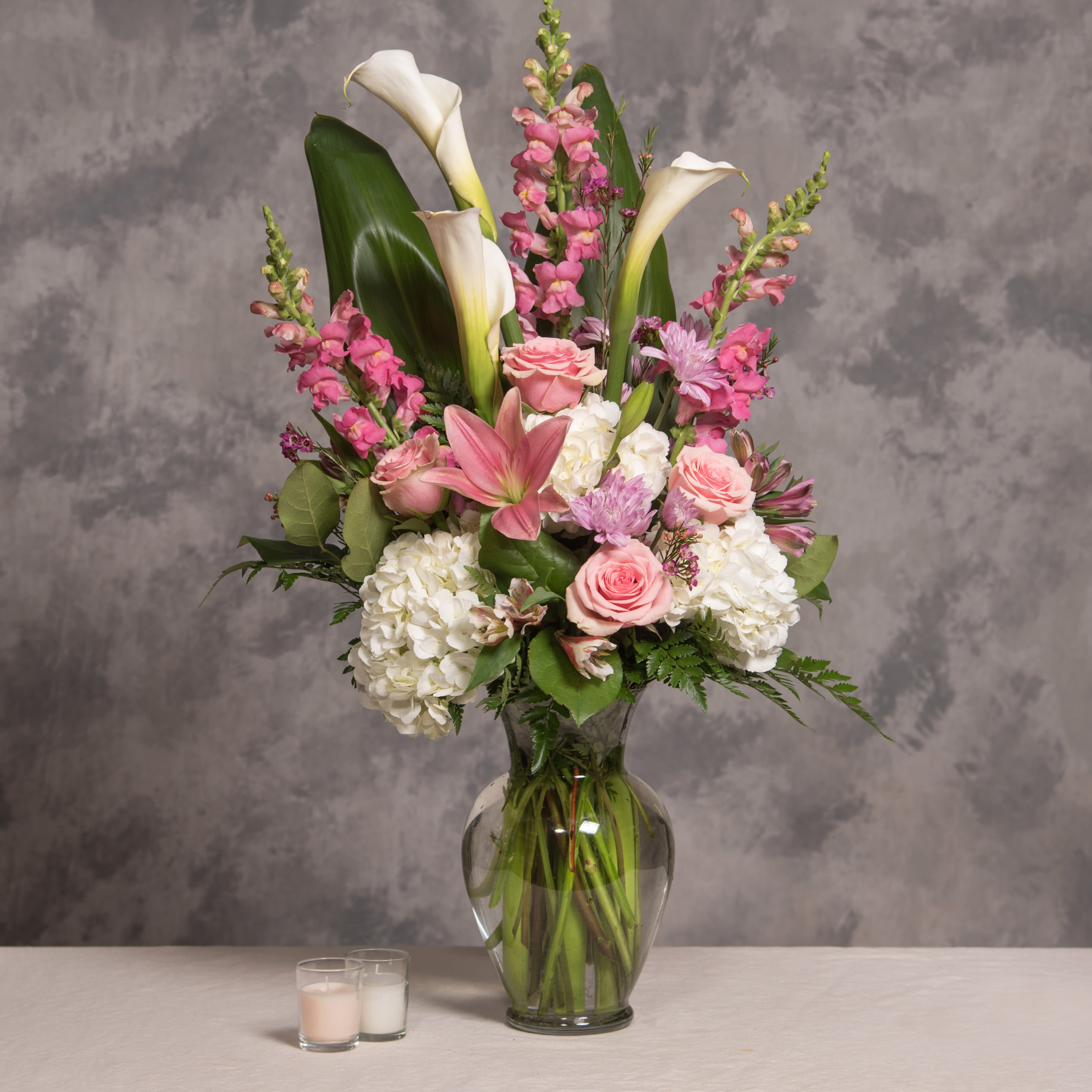 Pink and white floral arrangement in a clear glass vase