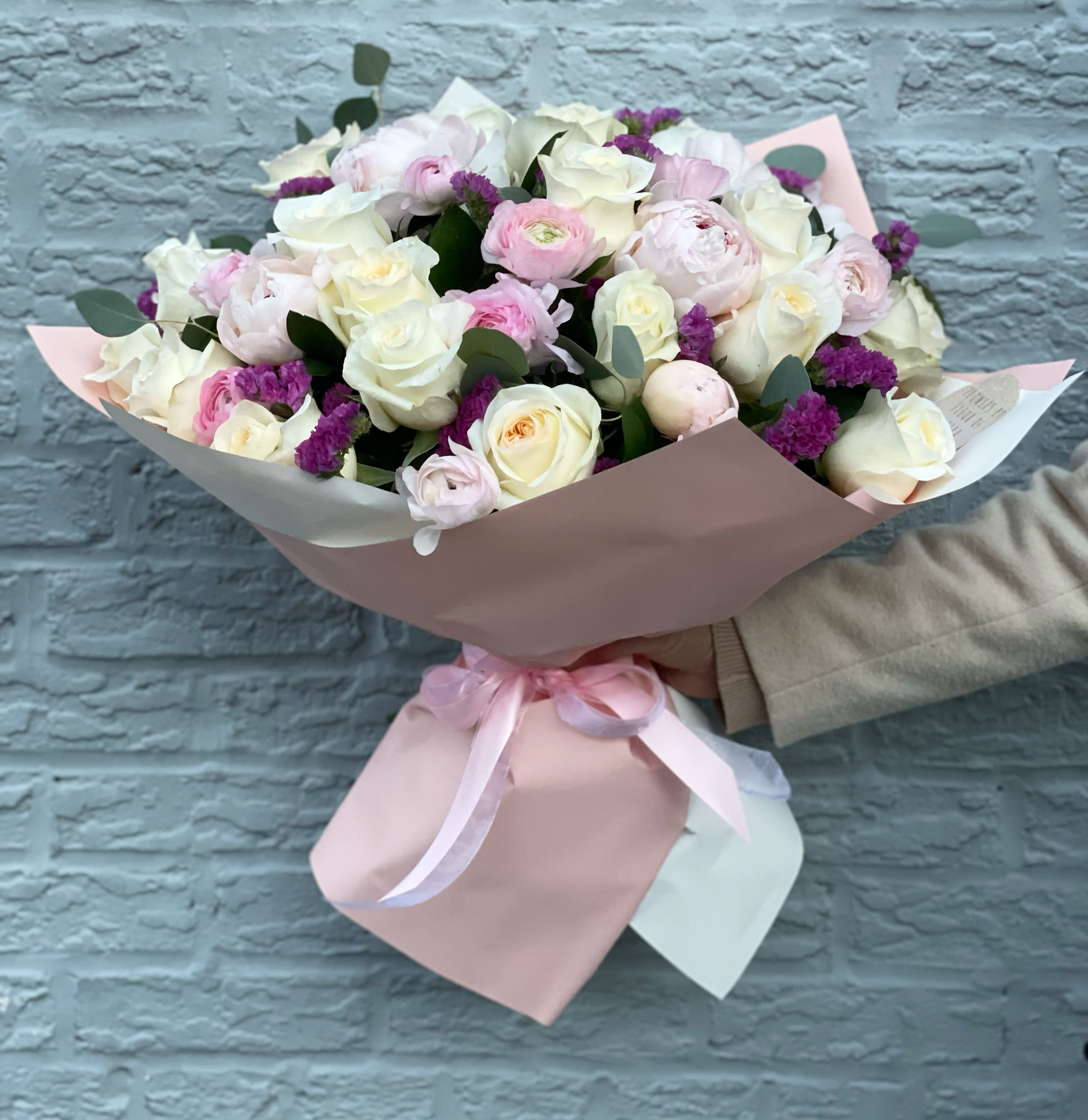 Incredible bouquet with peonies, ranunculus and white roses. The photo shows a deluxe size. - The photo shows a standard size.
