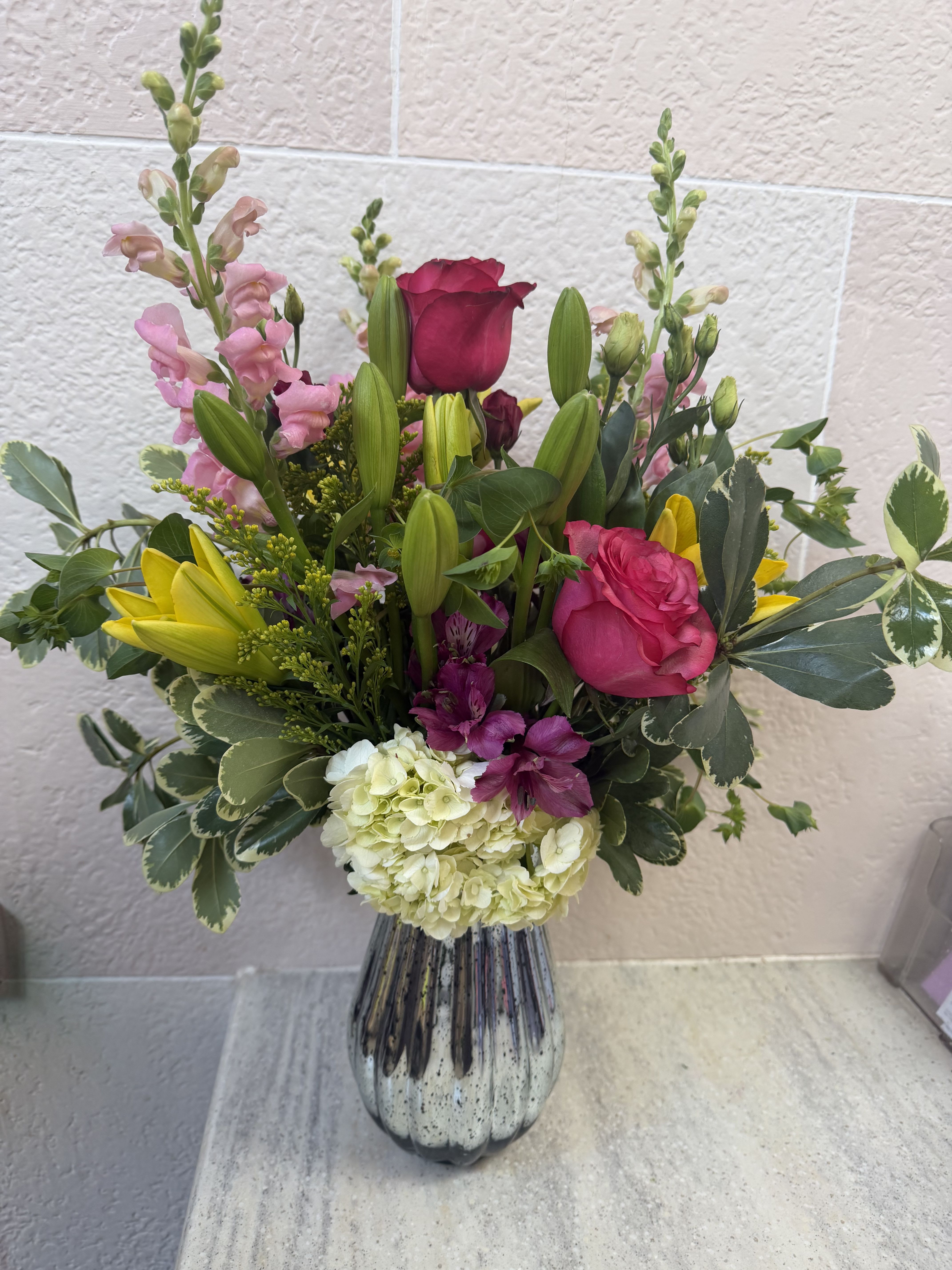 Inspired by Mom Vase - Mother's Day Special  - A silver or gold vase filled with pink and purple blooms with a pop of bright yellow. Flowers include asiatic Lillies, snapdragons, roses, and more. 