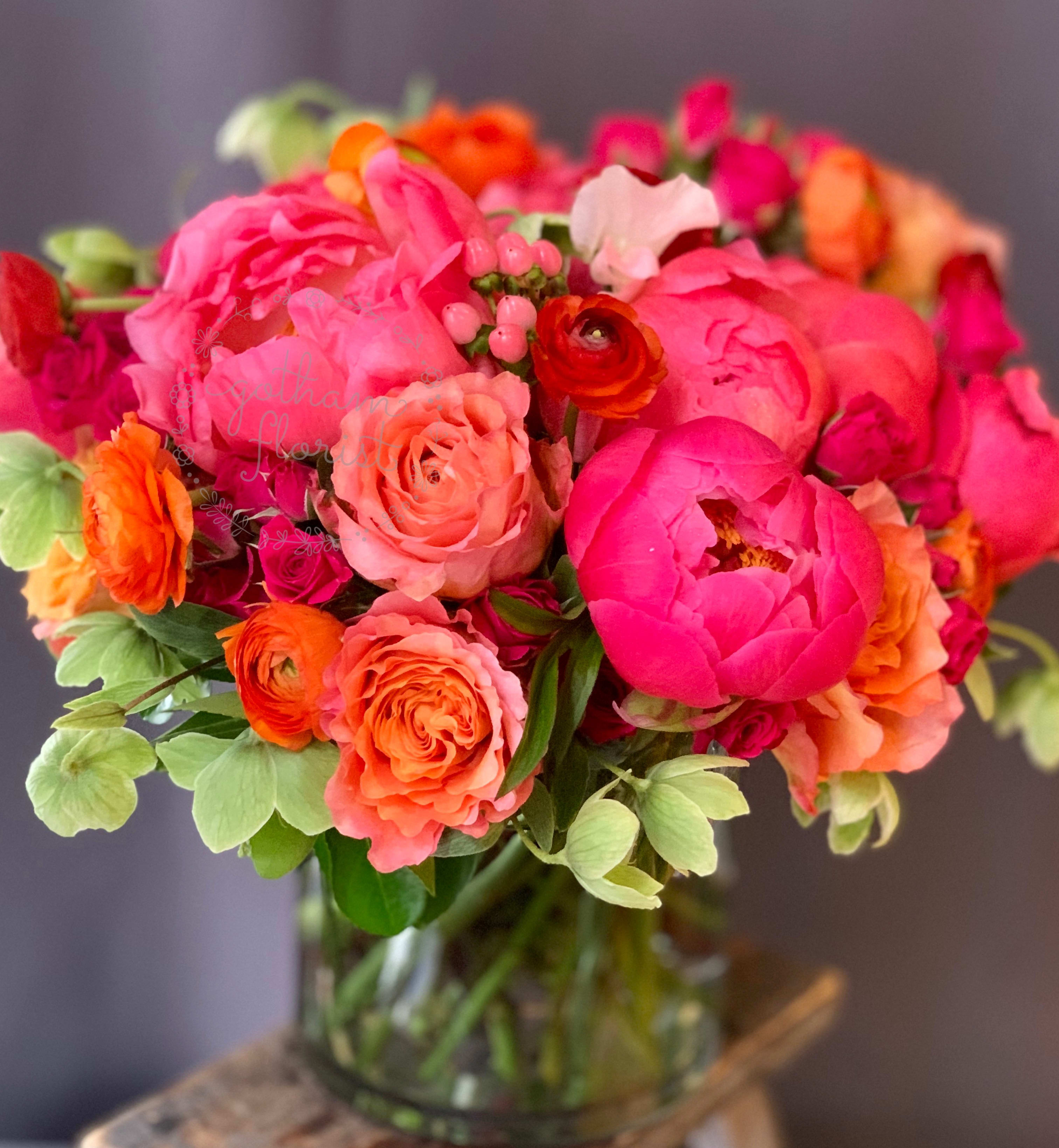 In My Heart - Prepare to be swept away by the sheer opulence of "In My Heart" - a floral masterpiece that celebrates the allure of peonies in all their glory. Lush hot pink peonies Romantic orange and pink roses Charming ranunculus Accented with verdant green hellebores This lavish arrangement is a true feast for the eyes, blending vibrant hues and sumptuous textures into a captivating display. Indulge the peony lover in your life with this stunning bouquet that elevates any space with its natural splendor.  Who is it for? If you know someone who adores the ethereal beauty of peonies, this arrangement is the ultimate expression of your affection. Watch their face light up as they immerse themselves in the captivating colors and delicate fragrances of nature's finest blooms.  We offer same day flower delivery in Manhattan, Queens, Bronx, Brooklyn, Staten Island and West Chester counties. We have the prettiest and most luxurious flowers to choose from and our designs are unique and whimsical. We carry Peonies almost every day of the year!! Best florist, nyc, local florist, send flowers, flower delivery, same day delivery, florist around me, flower shop, best flower shop, flowers, flower delivery, peony, peonies, same day flower delivery,  wedding florist, best florist nyc, nyc florist, florist near me, manhattan florist,  brooklyn florist