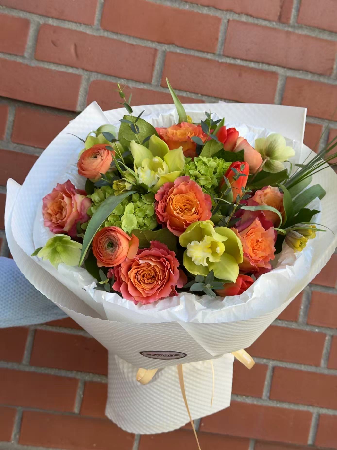 Sunset Orchard - Radiant, lush, and full of life, the Sunset Orchard Bouquet captures the warmth of a golden hour glow. This masterfully curated arrangement blends rich citrus tones with refreshing greens to create a visual masterpiece that feels both modern and timeless.