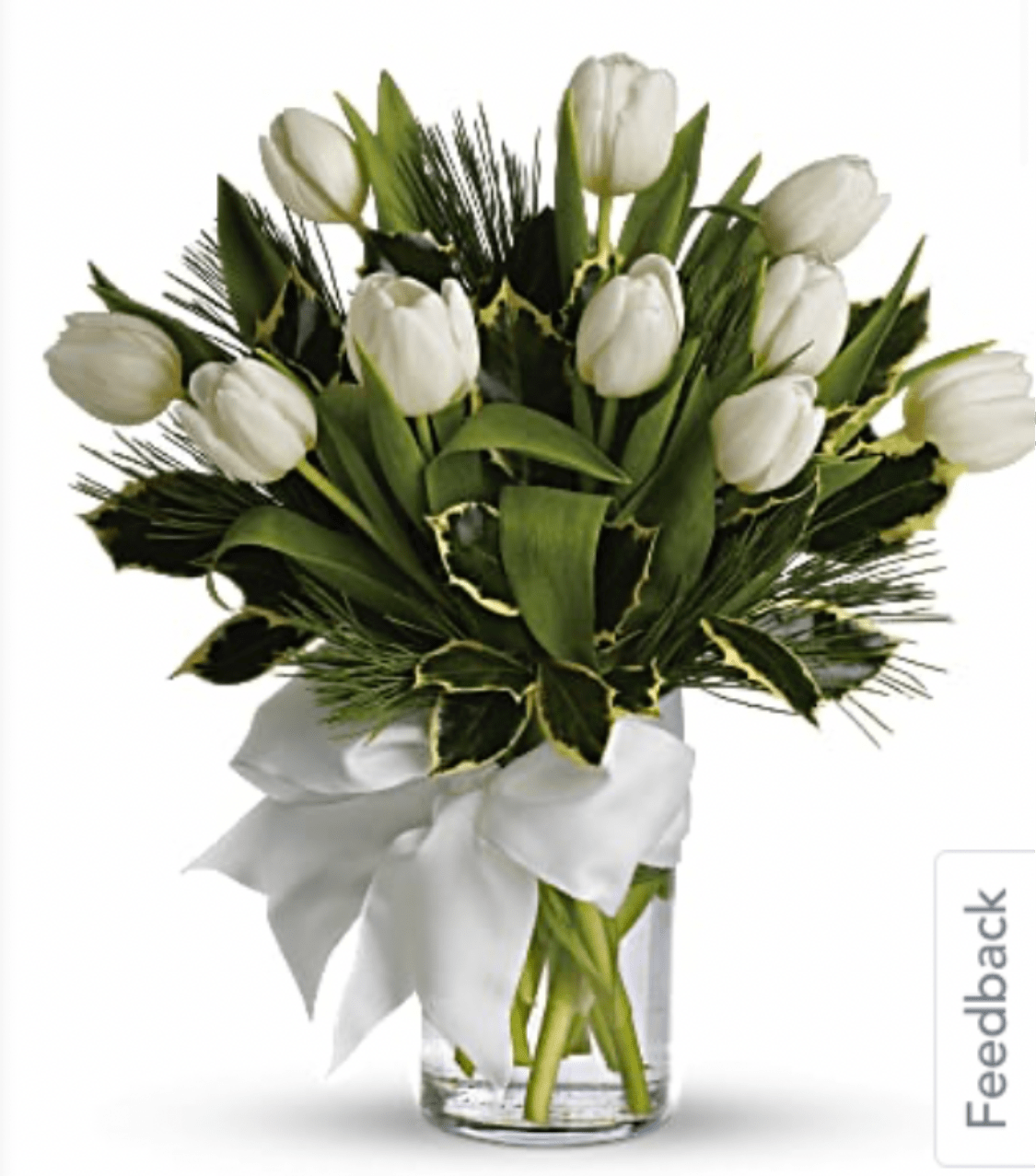 White tulip bouquet in a clear glass vase with a white ribbon