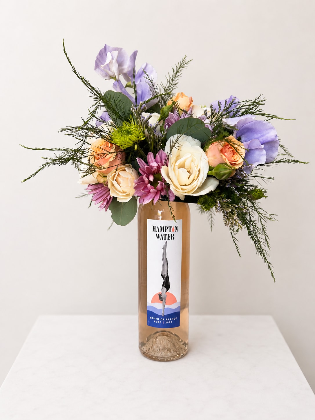 Booze-quet - Rosé (375ml) - New at The Virginia Florist! A beautiful, seasonal arrangement on top of a high quality bottle of wine (mini version)! What more can you ask for? When you're ready to enjoy the wine, easily lift off the arrangement and set in a shallow dish with water.