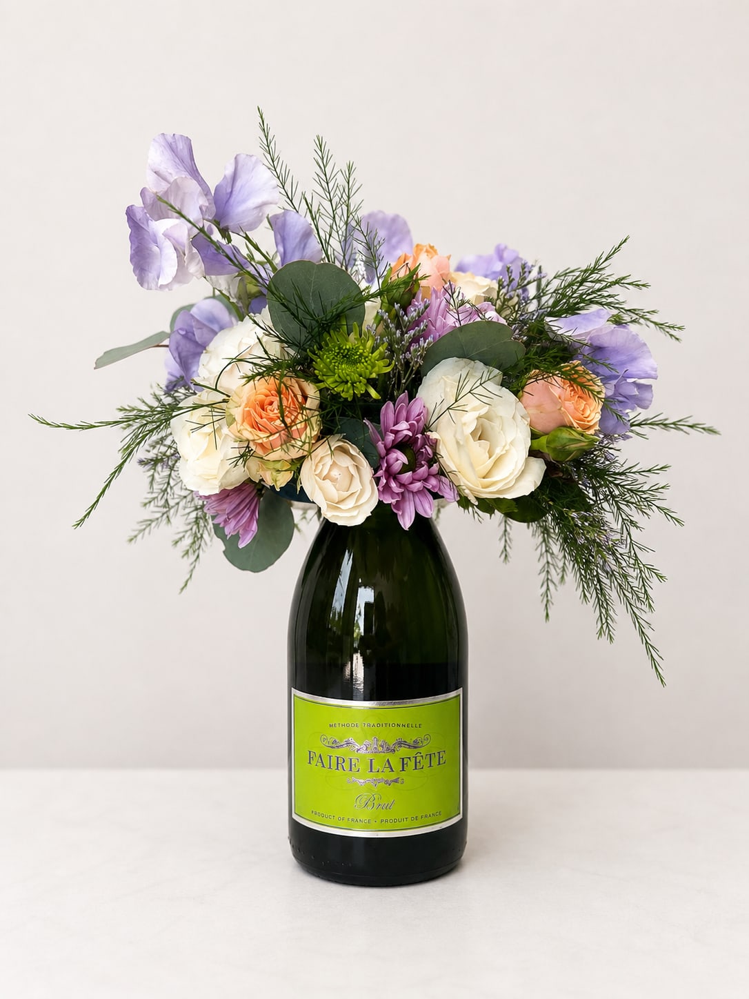 Booze-quet - French Sparkling Wine (750ml) - New at The Virginia Florist! A beautiful, seasonal arrangement on top of a high quality bottle of French bubbly! What more could you ask for? When you are ready to enjoy your wine, easily lift off the arrangement and keep in a shallow dish of water to continue enjoying it's beauty.