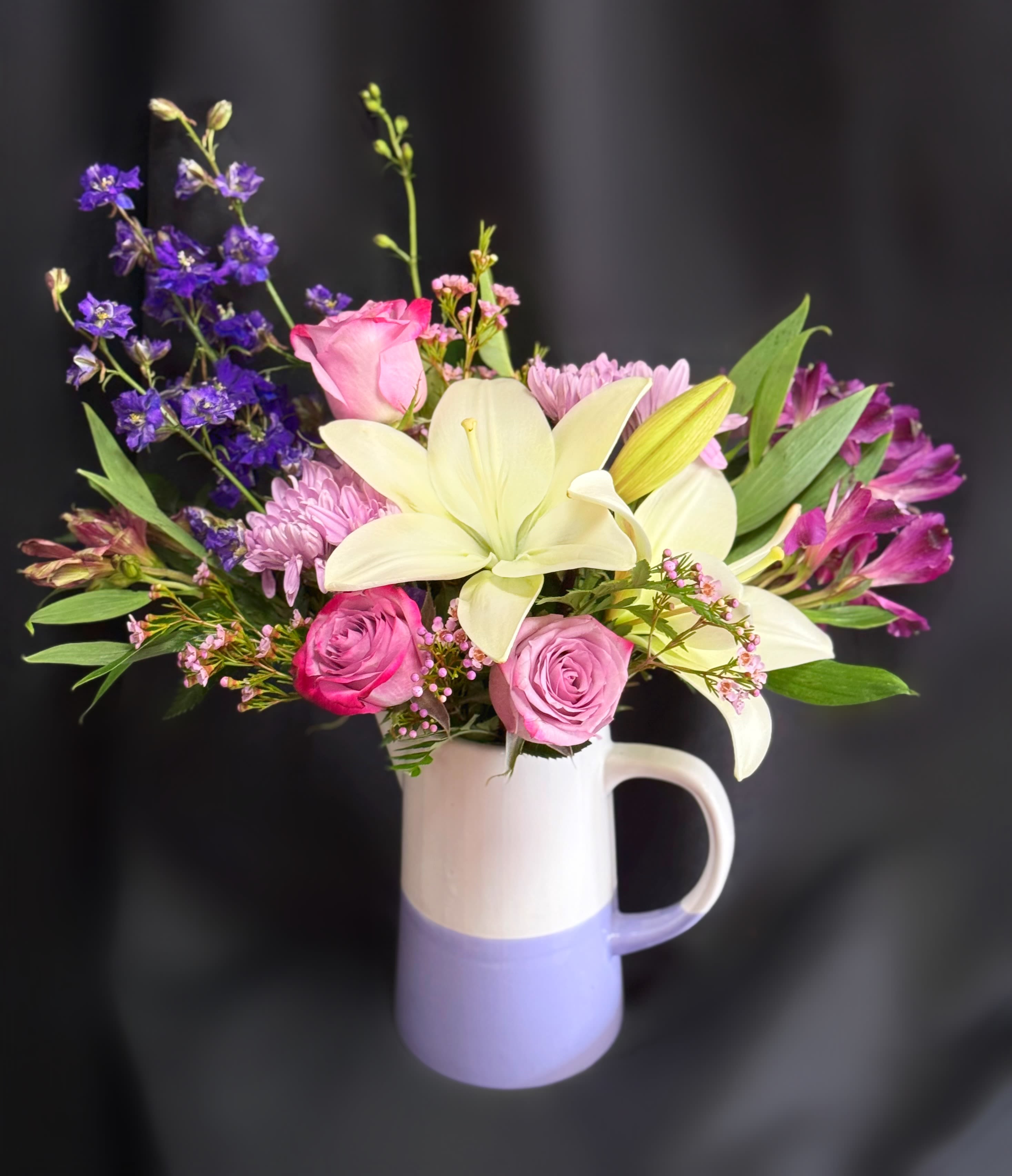 Lovely Lavender Pitcher  - Lilies, roses, alstro, and daisies in a lavender and white pitcher 