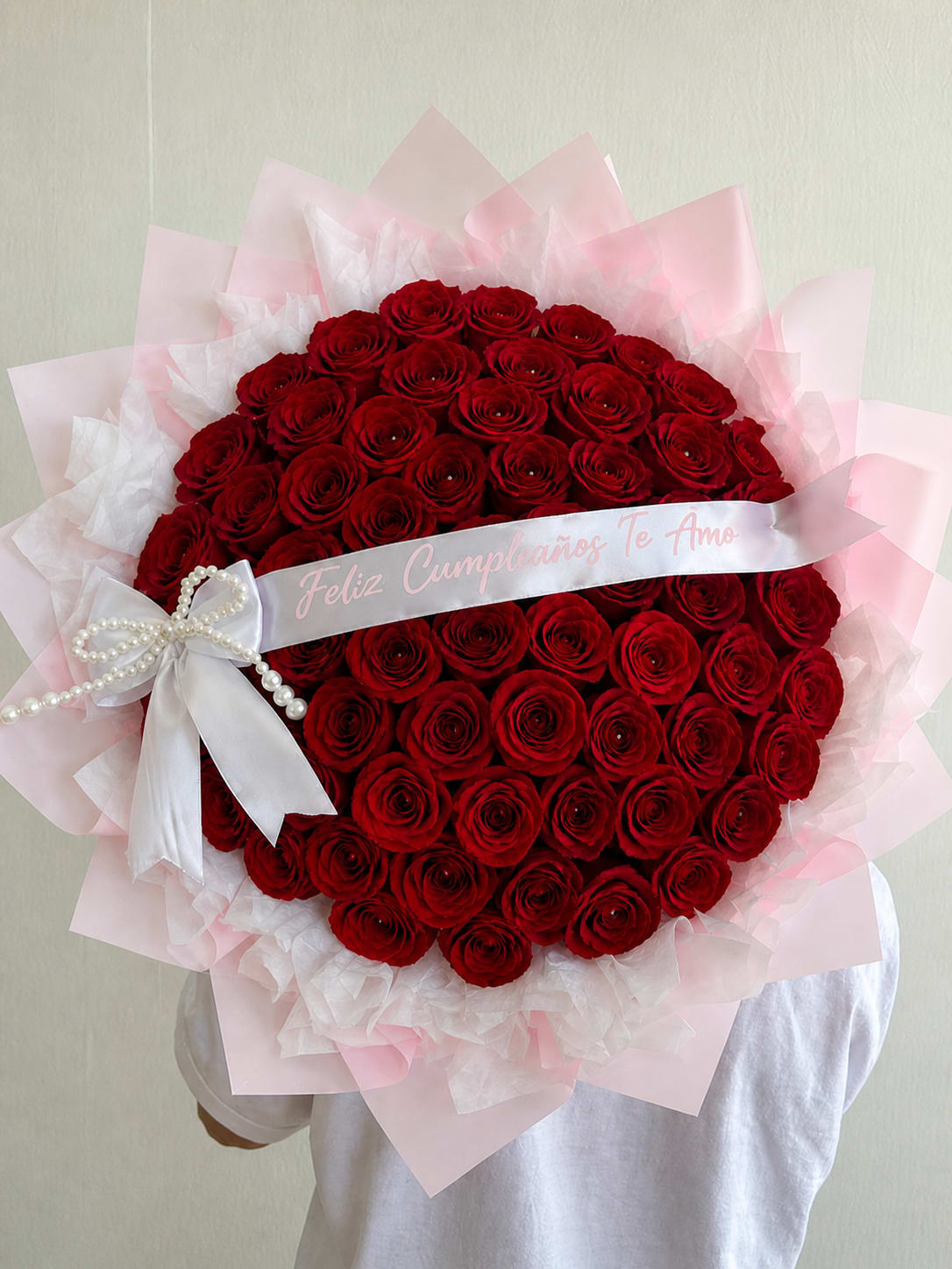 Floramar Bouquet - A breathtaking arrangement of premium red roses, beautifully styled in a full dome shape and wrapped in soft pink layers with elegant ribbon detail. Luxury Red Rose Dome is designed to make a bold and unforgettable statement—perfect for expressing deep love, passion, and celebration.