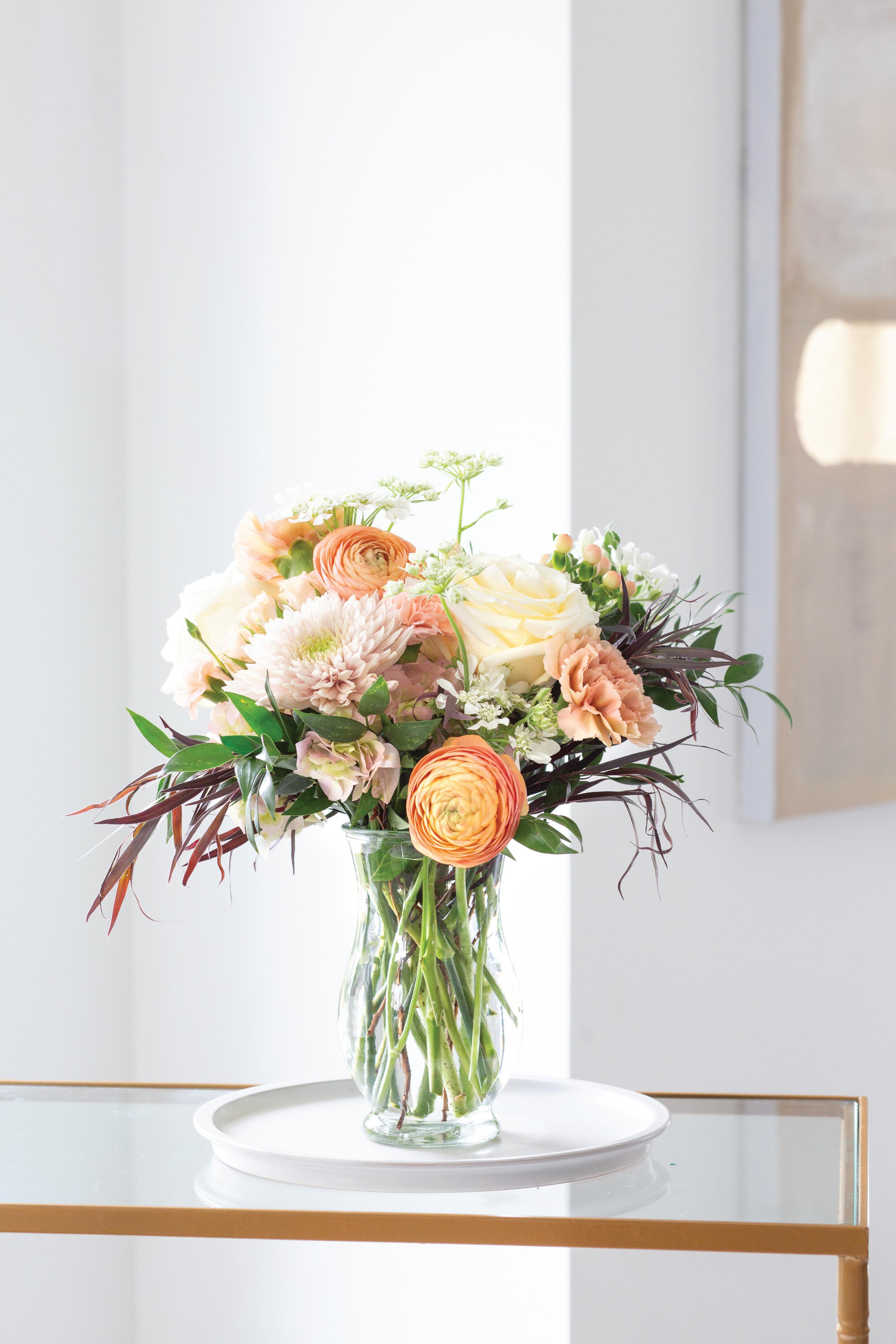 Peach Blossom Garden Vase - A soft, garden-style floral arrangement designed in warm peach, blush, and cream tones.  Light, airy, and naturally styled, this arrangement brings a fresh and inviting feel to any space. Designed with seasonal blooms and organic movement, it offers a balanced look that feels full without being overwhelming.  Perfect for birthdays, thank you gifts, or simply brightening someone’s day.  Details: Garden-style, soft and airy design Peach, blush, and cream color palette Seasonal blooms with natural movement Glass vase  Ordering Available for flower delivery in DeLand and surrounding areas including Deltona, Lake Mary, and Sanford. Order online or by phone for same-day or next-day delivery.  Design Note Each arrangement is uniquely designed using the freshest seasonal blooms available. While the overall style and color palette will be honored, exact flowers and placement will vary.