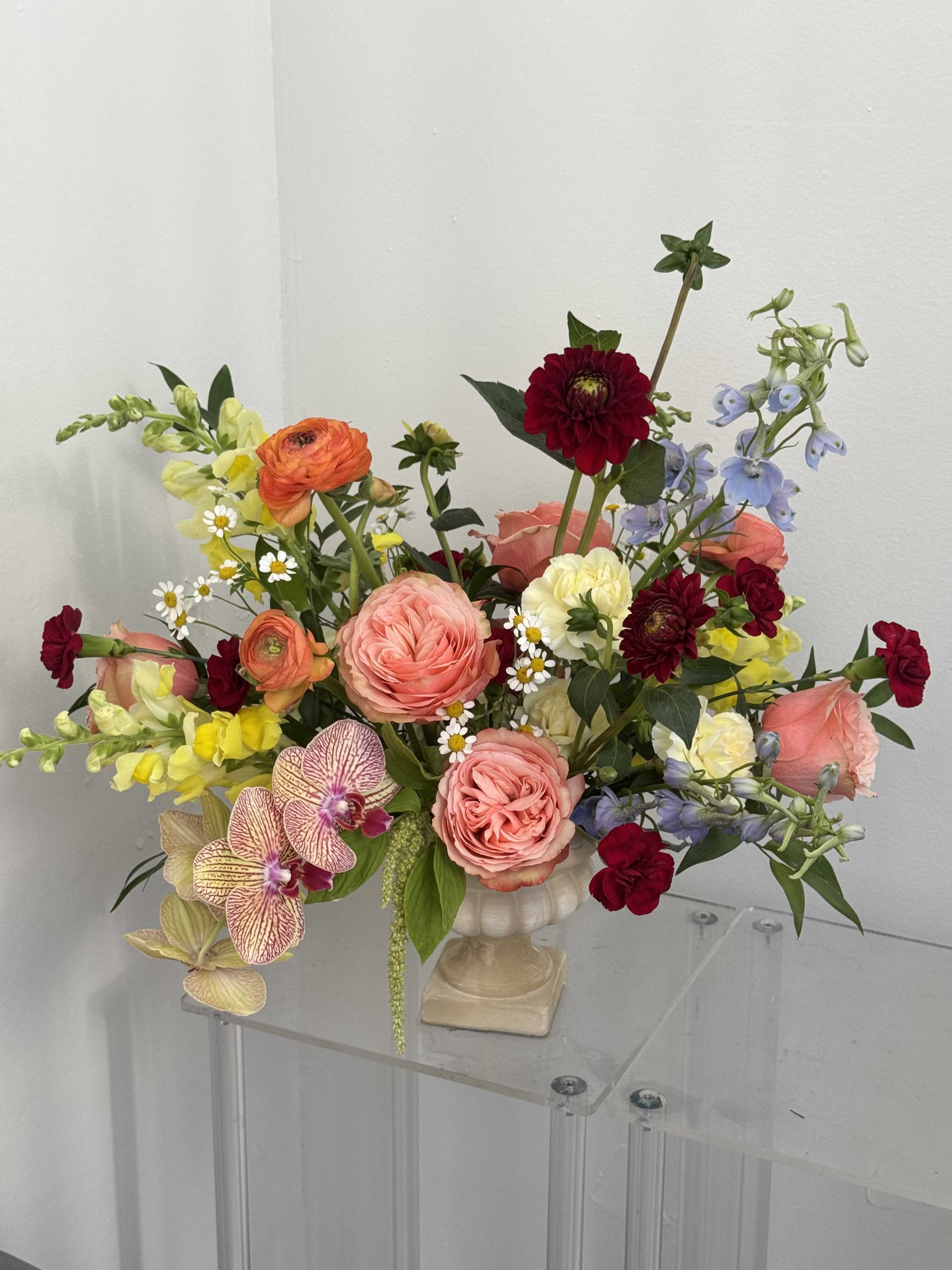 Sunset Garden - A bright, garden-fresh centerpiece that feels like a pocket of sunset-perfect as a birthday bouquet, anniversary arrangement, or a "just because" surprise for someone you love. The Sunset Garden flower arrangement combines warm reds, peaches, oranges and sunny yellows to create an uplifting, romantic feel that also suits graduations, new baby celebrations, Mother's Day, or a thoughtful "thinking of you" gift.