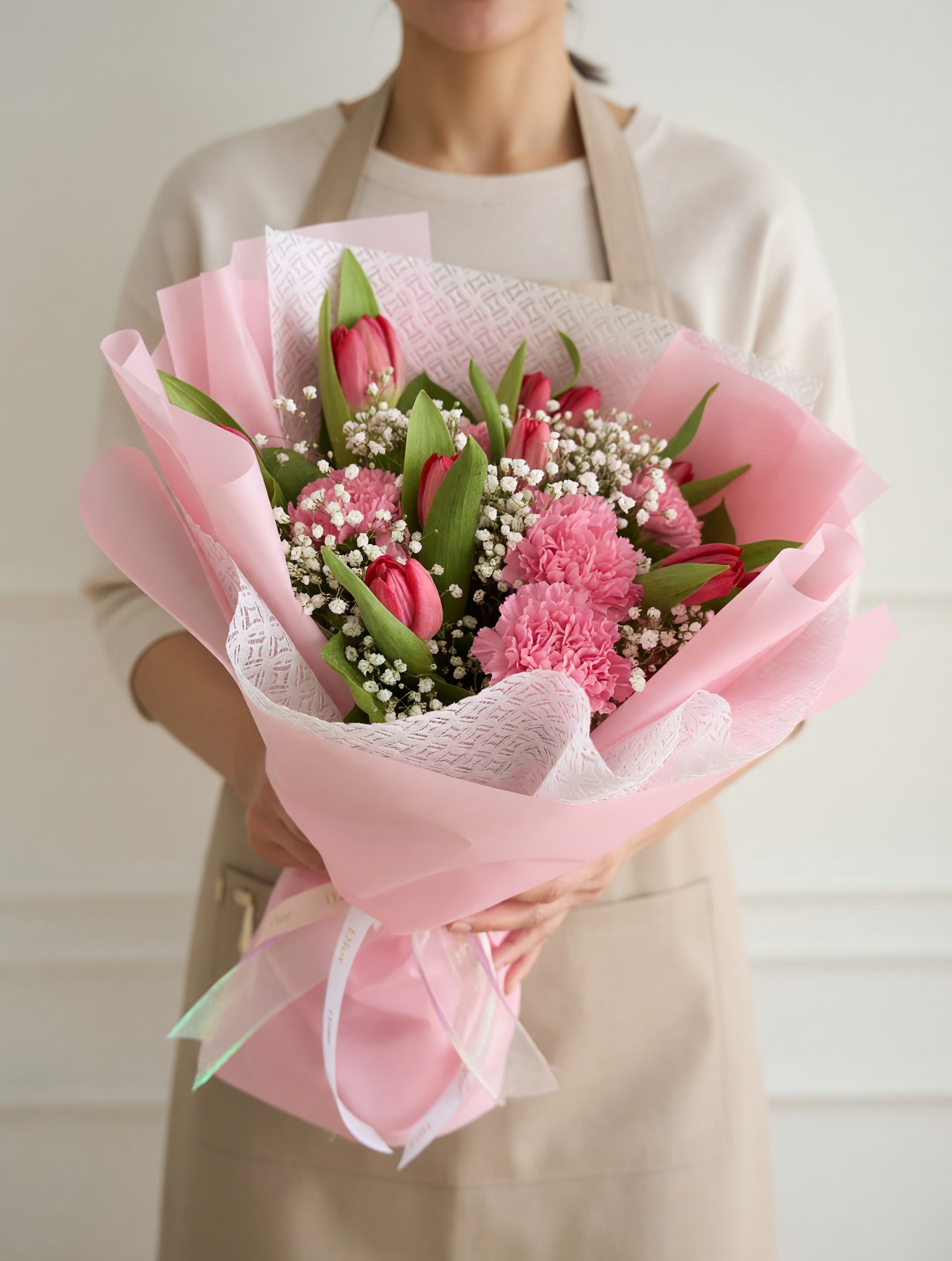 Tulip &amp; Carnation Bouquet - A charming bouquet featuring soft pink tulips, delicate carnations, and baby’s breath, beautifully arranged with fresh greenery and wrapped in elegant pastel pink layers. Blush Tulip &amp; Carnation Bouquet is designed to express sweetness, affection, and gentle love—perfect for thoughtful and heartfelt gifts.