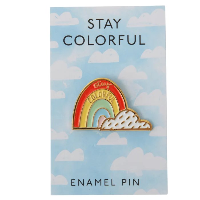 Rainbow enamel pin on a cloud-patterned card