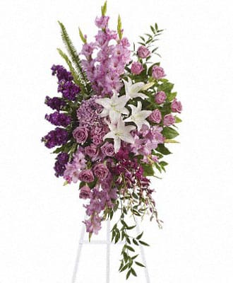 Tall standing spray of purple and white flowers on an easel