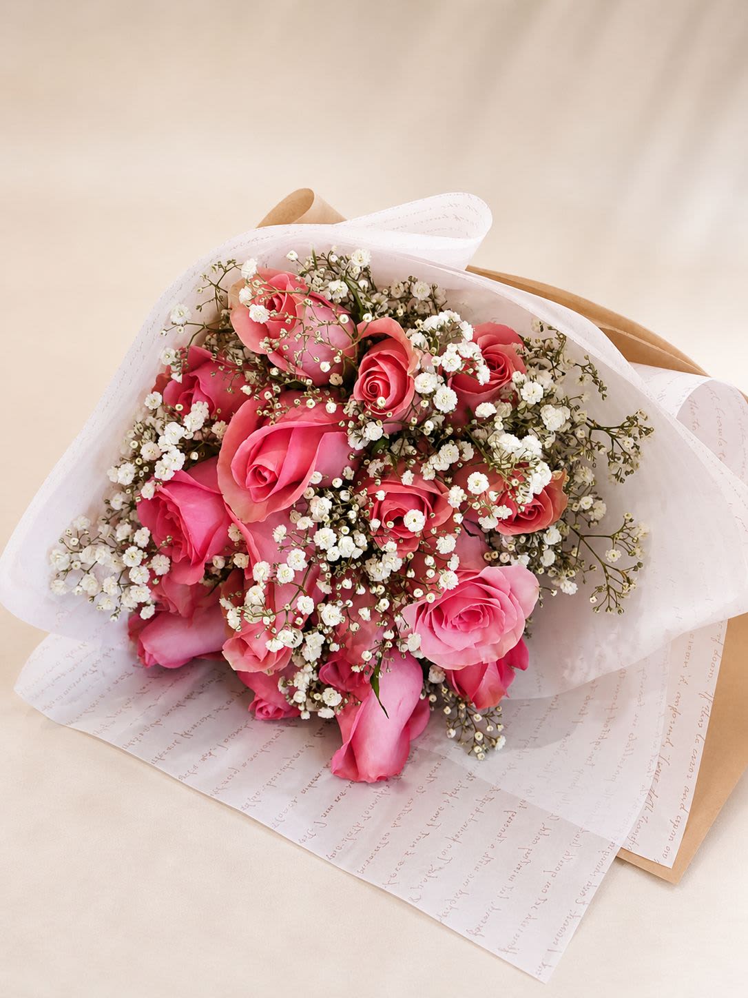 Sweet Blush Roses Bouquet – by Romina’s Flowers - A timeless and romantic bouquet featuring soft pink roses paired with delicate baby’s breath, wrapped in an elegant translucent paper. Designed with a classic and feminine touch, this arrangement is perfect for expressing love, appreciation, or celebrating special moments.