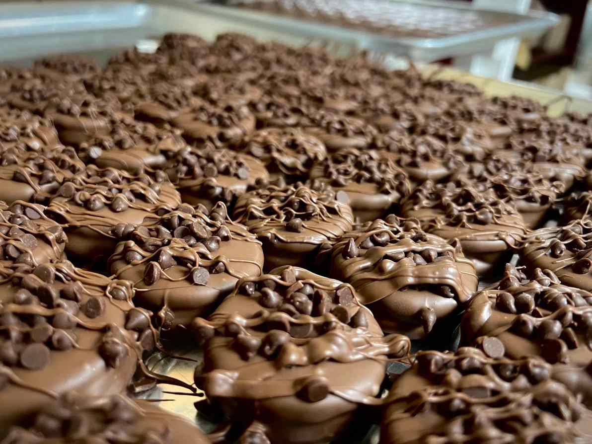 Chocolate Covered Oreos 2 Pack - A playful pair of indulgent gifts, these Chocolate Covered Oreos 2 Pack make a sweet surprise for birthdays, party favors, or just because you're thinking of someone who loves fun treats. This dessert-style arrangement presents two large baking trays of individually coated Oreos-one tray with classic milk chocolate shells finished with extra drizzled chocolate and mini chips for a rich, textured look, and a second tray topped with whimsical molded dog-face decorations in brown, white, tan, and dark accents that bring a lighthearted, novelty touch.  Each tray is densely arranged for an abundant, shareable presentation that reads like a celebration on a baking sheet-perfect for casual gatherings, holiday dessert tables, or gifting to a child or dog-lover who'll appreciate the cute faces. The mix of smooth milk chocolate, piped detail, and playful toppings creates contrast in color and texture (brown, white, tan, orange and black accents) so the recipient feels both delighted and spoiled. Packaged on a sturdy tray, these treats are ready to give and easy to pass around at parties.