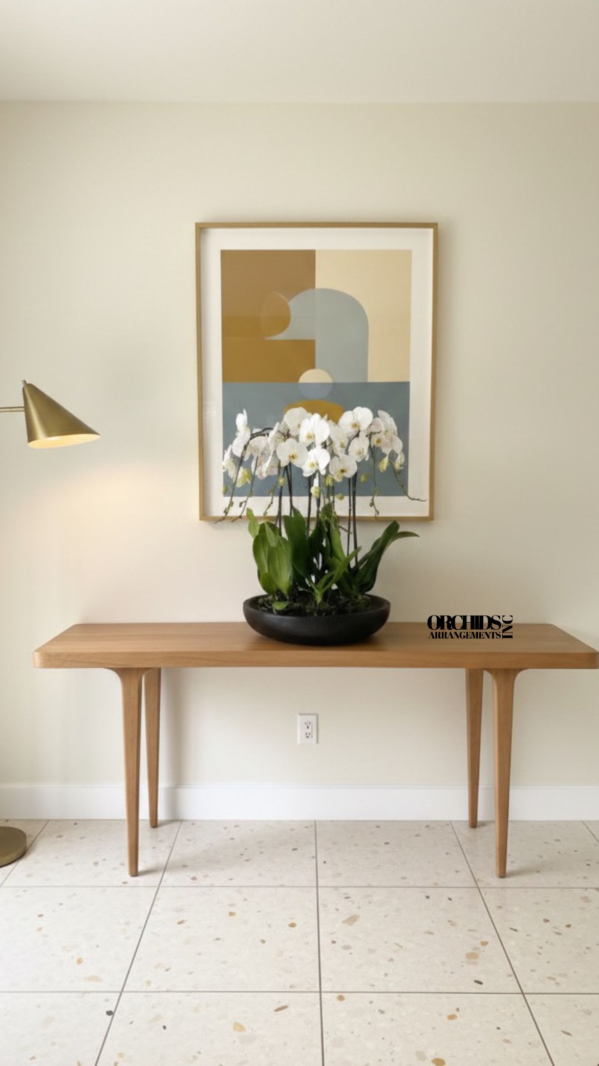 White orchids in a black bowl on a wooden table