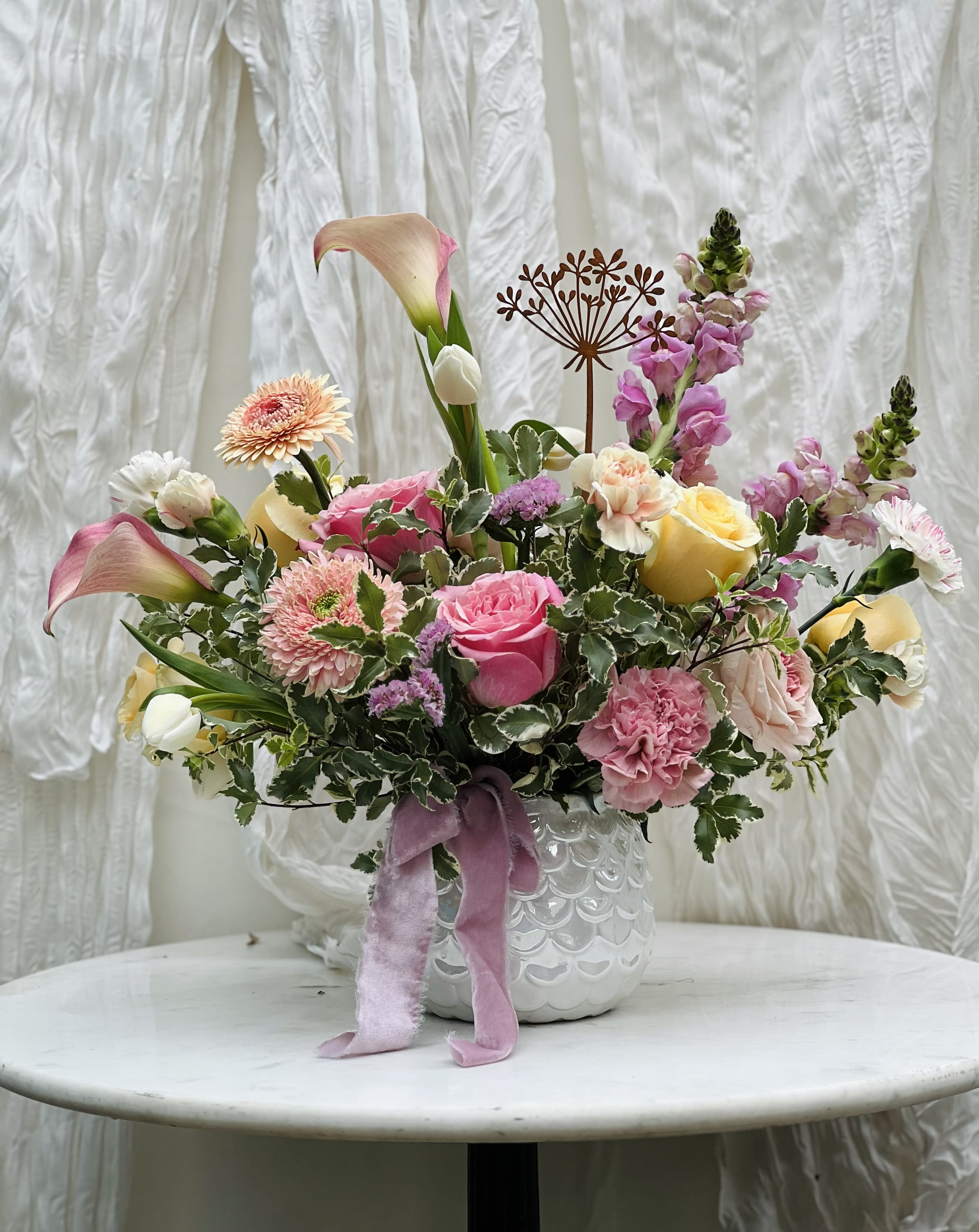 Eloise - Perfectly pastel, this elegant, stylized design is sure to impress this Valentine’s Day! Designed with premium garden style florals in a high end vase, this is one of our most popular arrangements!  Flowers and greenery may vary due to seasonal availability, but that’s part of the charm! Our creative designers will substitute with the freshest high end product available- some grown in our very own garden!- and create something beautiful.  *Have a special request?* Let us know in the special instructions section during checkout.