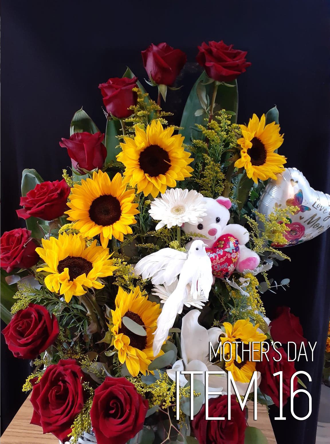 Bouquet of red roses and yellow sunflowers with a teddy bear and heart balloon