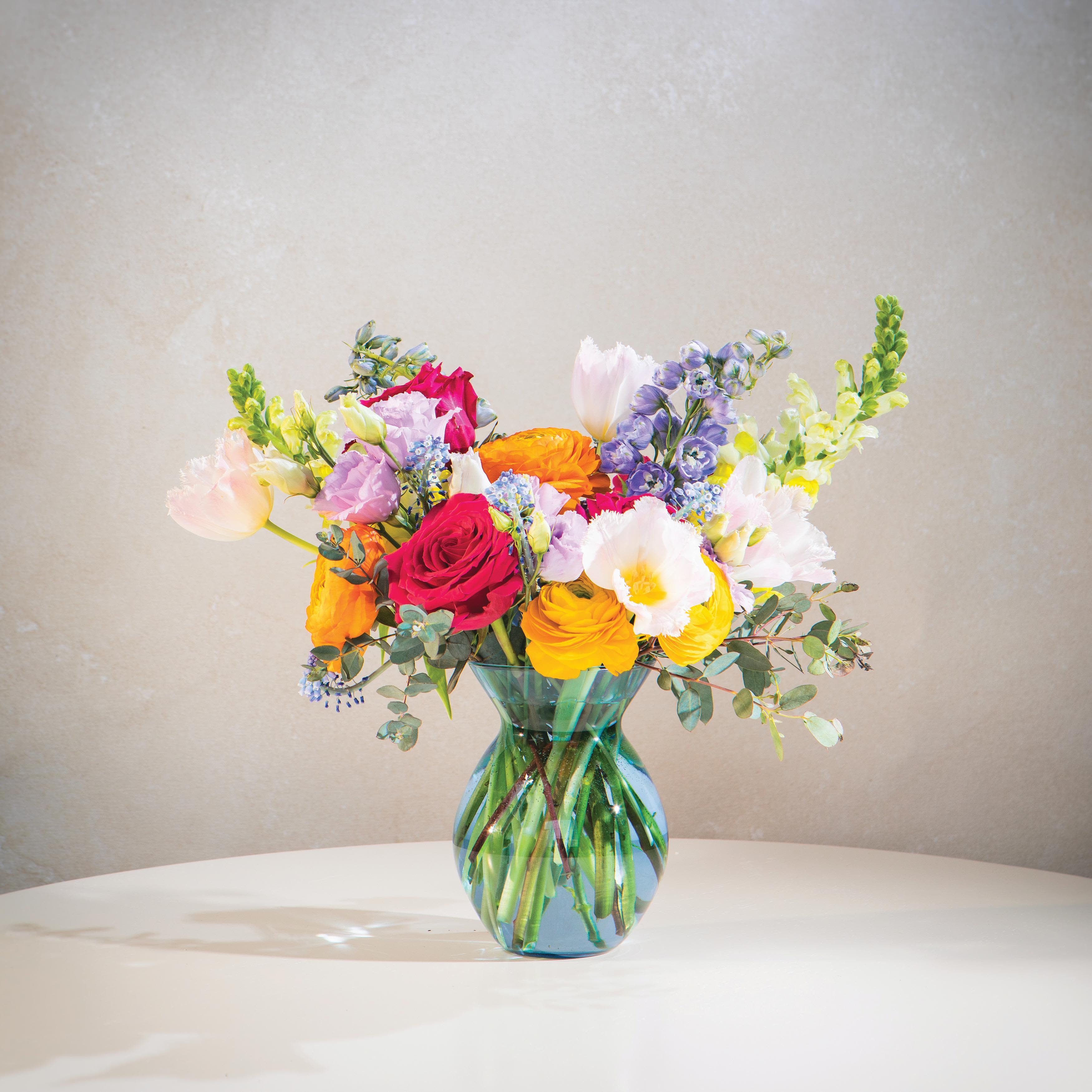 Sunset Meadow Vase - A bright, colorful flower arrangement designed to bring joy, energy, and warmth into any space.  Sunset Meadow features a vibrant mix of pink, yellow, and soft purple tones arranged with natural movement in a colored glass vase. Fresh, lively, and easy to gift, this design is perfect for birthdays, celebrations, or sending a cheerful surprise.  Available for same-day flower delivery in DeLand, with service to nearby areas including Lake Mary and Sanford.