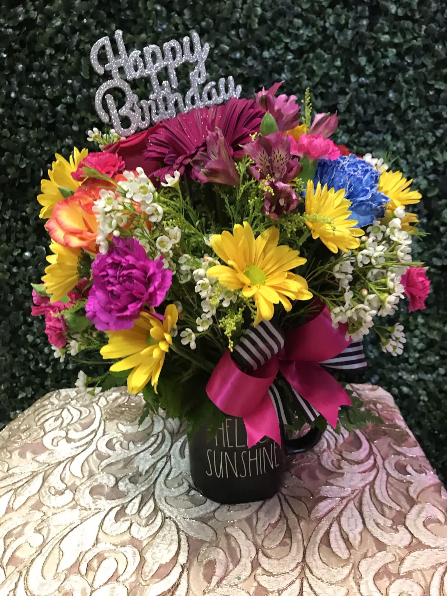Colorful birthday bouquet in a black mug with a glittery topper