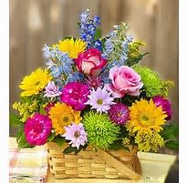 Colorful mixed bouquet in a wicker basket