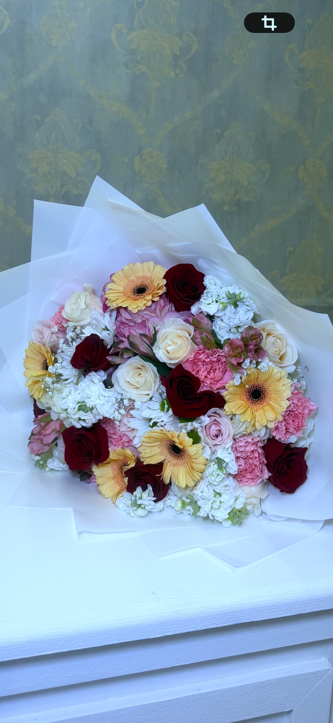 Colorful Joy – Seasonal Flower Bouquet - An exclusive bouquet full of color, elegance, and sophisticated design   Features a refined mix of gerbera daisies, multicolor roses, carnations, alstroemeria, statice, and seasonal flowers, creating a visually stunning arrangement.  Wrapped in premium paper with an elegant ribbon bow, perfect for upscale gifting.   Ideal for special occasions and unforgettable moments.