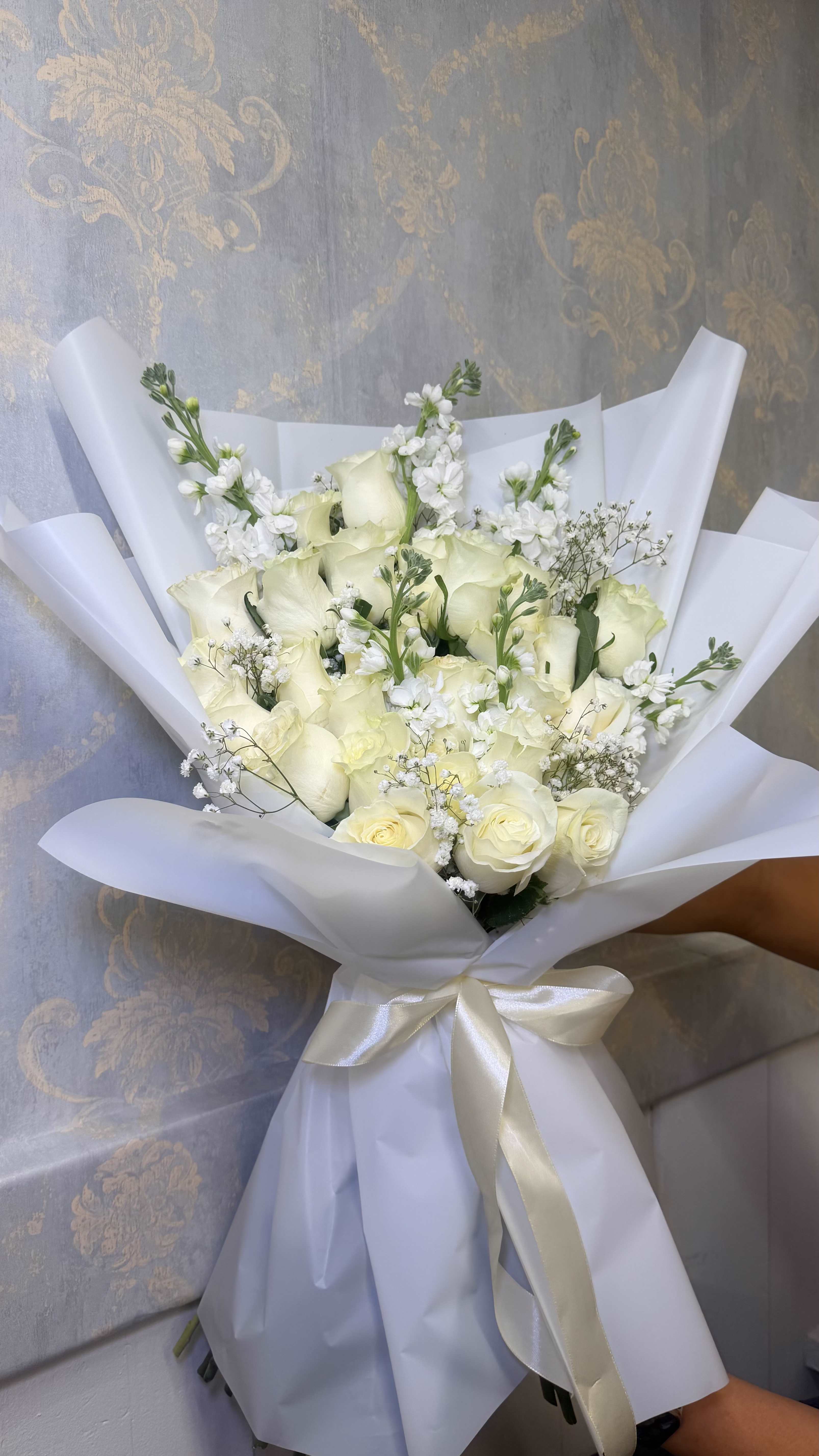 Pure Elegance – Bouquet Premium  - An elegant and sophisticated bouquet that represents purity, love, and beauty   Designed with beautiful fresh white roses, accented with baby’s breath, statice, and delicate floral details for a clean and modern style.  Wrapped in premium high-quality paper with an elegant satin ribbon bow, creating a luxurious presentation perfect for any special occasion.  A timeless and graceful gift that always makes an impression.