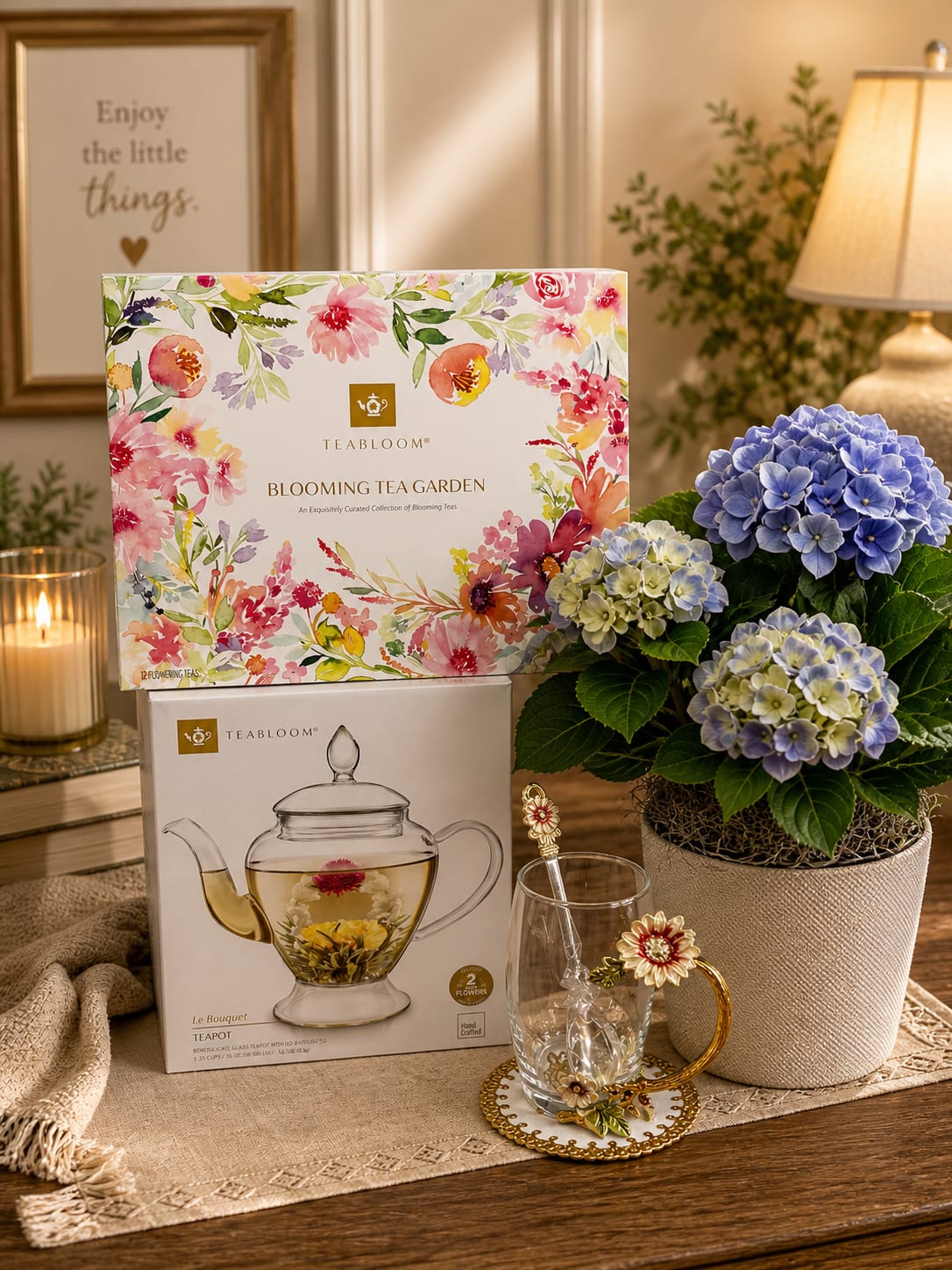 Hydrangea Tea Garden Luxe - An elegant luxury gift collection featuring a lush blue hydrangea plant, blooming tea garden assortment, handcrafted glass teapot set, and decorative floral tea cup with matching spoon. Designed to create moments of comfort, beauty, and relaxation, this sophisticated arrangement makes a perfect gift for Mother’s Day, birthdays, sympathy, thank you gifts, or any special occasion.