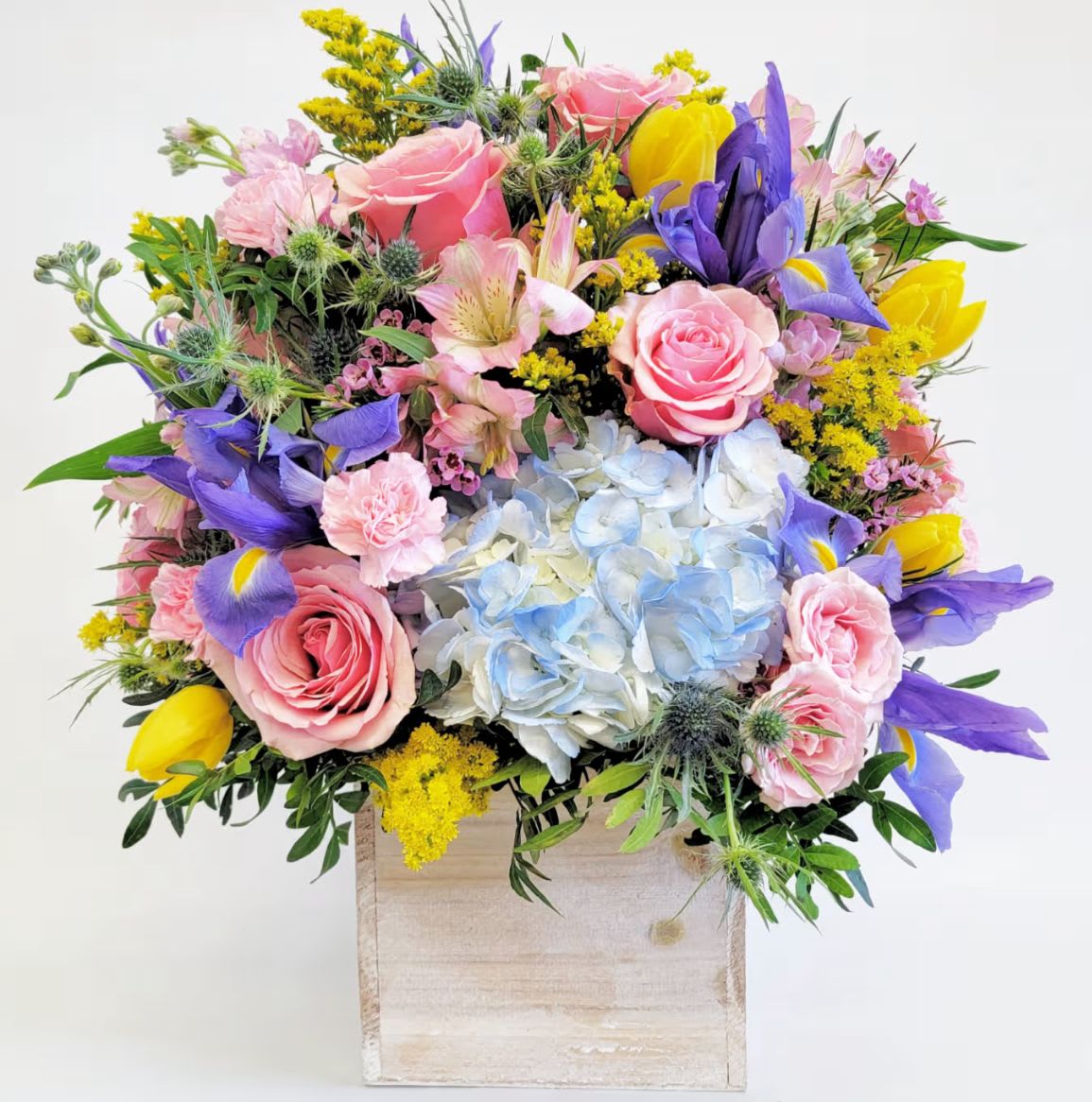 Mixed Spring Box - Variety of different spring flowers arranged in a wooden box. 