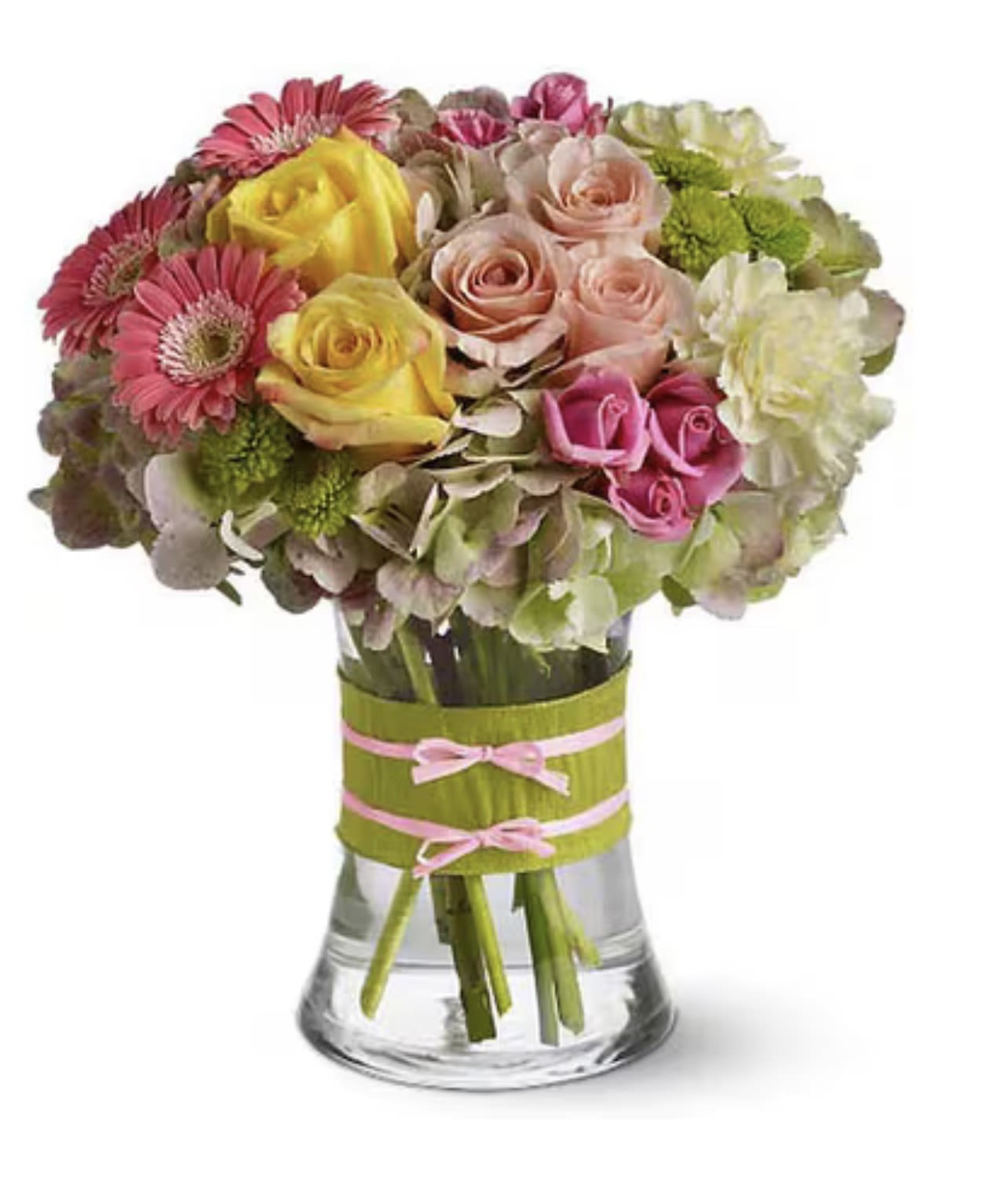 Fashionista - A rounded cluster of pink, yellow and blush roses mingles with cheerful pink gerbera daisies and pale hydrangeas to create a fresh, celebratory flower arrangement perfect for a birthday bouquet, a thank-you gift, or a springtime surprise. Fashionista's soft, feminine palette reads bright and joyful-the kind of arrangement that makes the person you're thinking of feel noticed and celebrated the moment it arrives.  This compact, full design is presented in a clear glass vase finished with a pink ribbon wrap, giving the stems a clean, modern look that complements the lush textures of roses, gerbera and hydrangea. The mix of warm yellows, gentle pinks and creamy whites with touches of green offers visual depth without feeling fussy; its size and rounded shape make it easy to display on tabletops, desks, or bedside tables. Order as a thoughtful everyday gift to mark birthdays, send thanks, or welcome spring-designed to arrive ready to brighten their day.