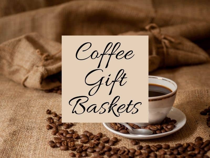 Coffee cup and saucer with coffee beans and a sign reading Coffee Gift Baskets