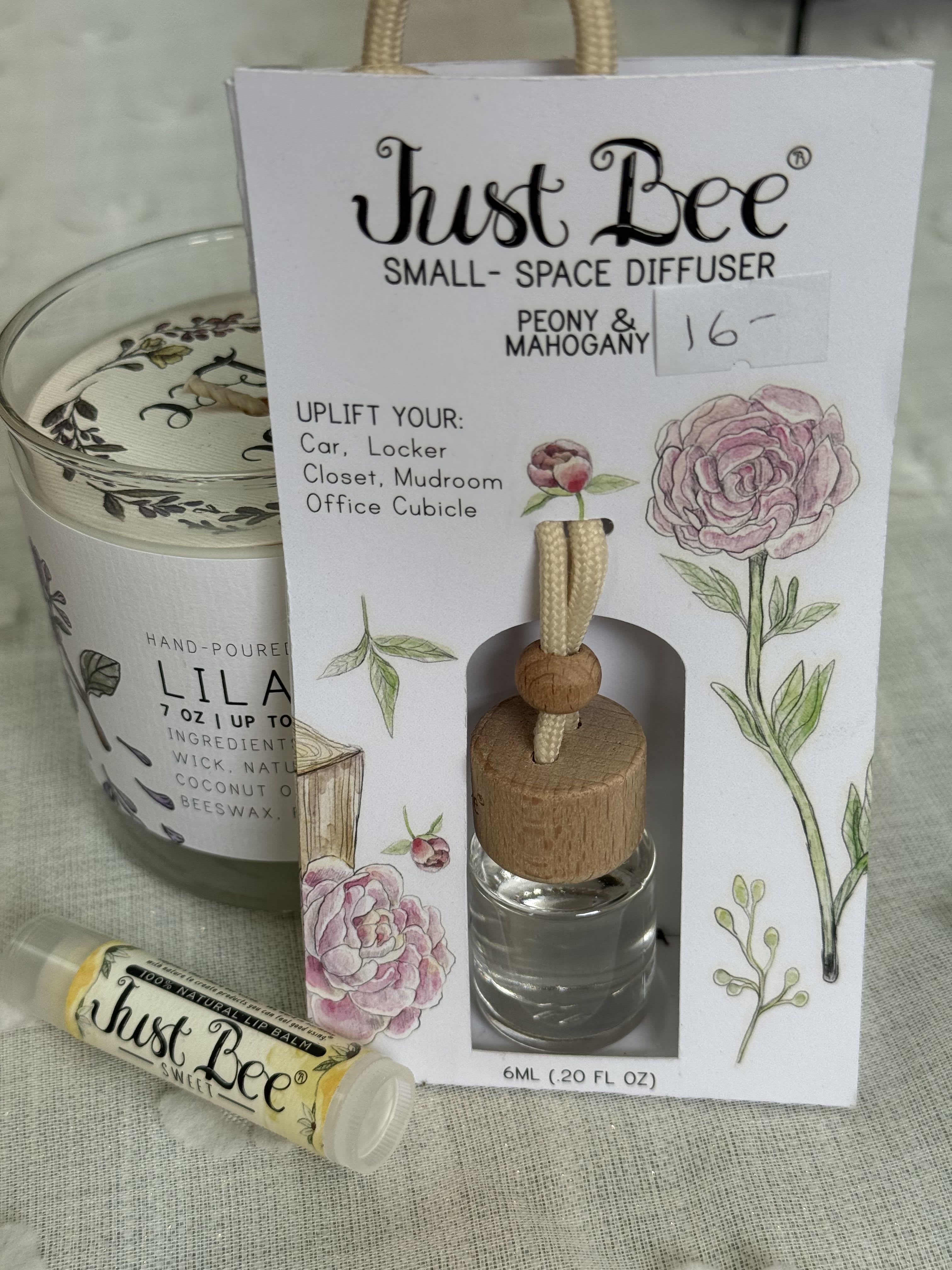 Just Bee Products - Soft pink peonies meet warm mahogany in a gift set built to comfort and delight-perfect as a Mother's Day bouquet alternative or a "thinking of you" present for birthdays, anniversaries, housewarmings, and more. This flower arrangement-inspired gift pairs the visual charm of watercolor peony art with scent-forward pieces, so the person you're honoring will feel noticed and pampered whether it's for Mother's Day, a get-well gesture, or a just-because surprise.  The set includes a small-space glass diffuser with a wood cap and braided cord, filled with peony and mahogany fragrance, accompanied by a coordinating candle jar and nourishing lip balm in a neat white gift box printed with soft pink peonies and botanical accents. Peony notes bring a fresh floral sweetness while the mahogany base adds warmth and depth-an inviting combination that reads feminine but never fussy. Compact and elegant, it fits on a bedside table, office desk, or bathroom shelf.  Give this as a thoughtful Mother's Day, birthday, graduation, thank-you, or anniversary gift-it's also a lovely choice for housewarming, get-well, retirement, or holiday exchanges when you want someone to feel truly seen. The set ships ready to present in its decorated box; for best scent life, keep the diffuser away from direct sunlight and replace reeds or refresh as needed to maintain fragrance.