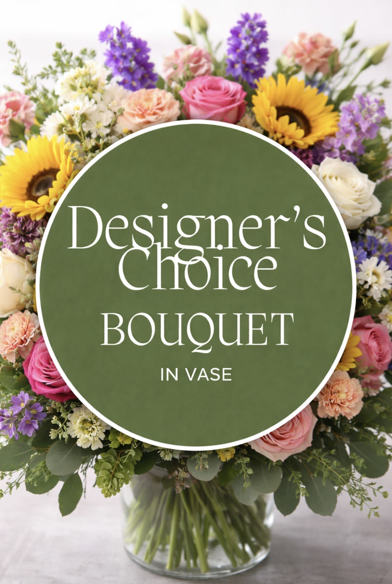 Mixed bouquet of sunflowers, roses, and other blooms in a clear vase with a text overlay.