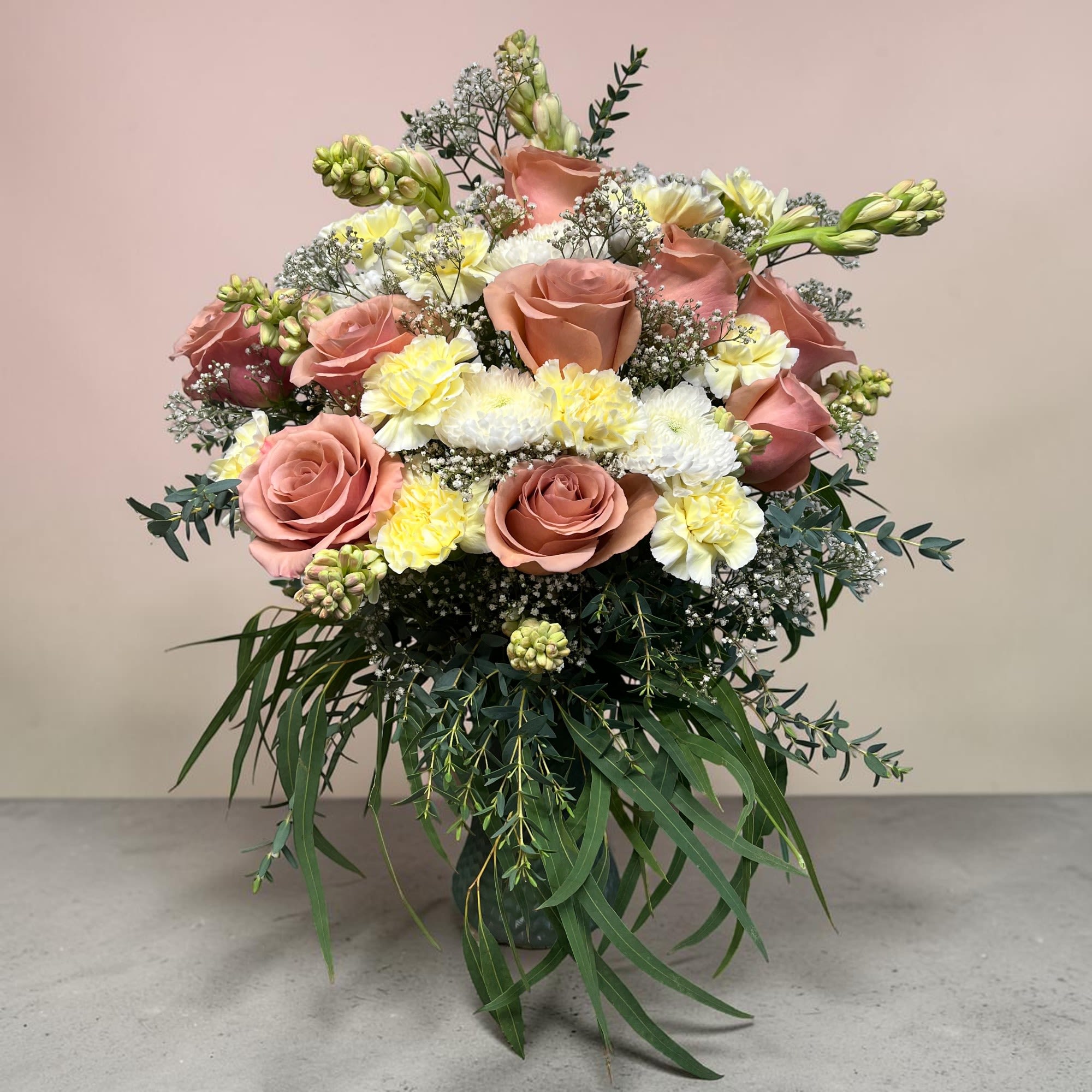 Peaches 'N Cream - Peaches 'N Cream is the most whimsical way to sweeten somebody's day. This beautiful boho arrangement with eucalyptus, peach roses, white chrysanthemums and cream carnations adds a feminine touch to any space.   APPROXIMATE DIMENSIONS: 22" W x 20" H