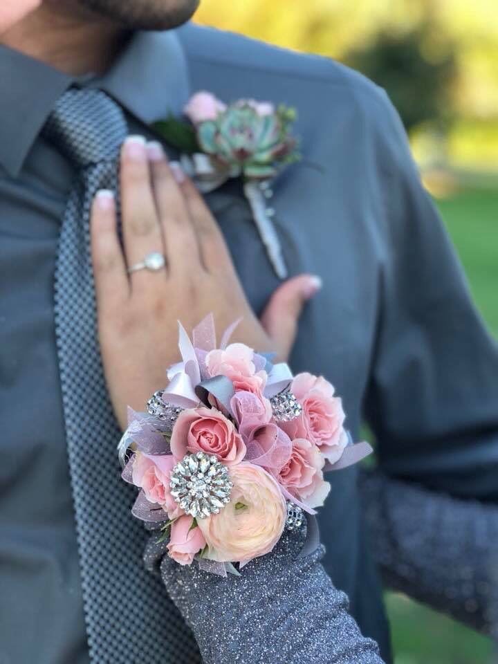 Blush Glam Corsage &amp; Boutonniere Set - This matching corsage and boutonniere set features fresh blush roses, ranunculus blooms, shimmering rhinestone accents, and delicate ribbon detailing for a glamorous and feminine prom look.  Designed with fresh flowers and elegant textures, this set adds a chic and romantic statement to your special night.  Includes: • Wrist corsage • Matching boutonniere • Fresh flowers • Rhinestone accents • Ribbon detailing  If you would like a different ribbon color to match your outfit or prom theme, please leave your preferred color in the notes section at checkout.    This design can be customized to match your dress or prom colors. Please leave your dress color or inspiration details in the notes section at checkout, and we will create a beautifully coordinated set just for you.  