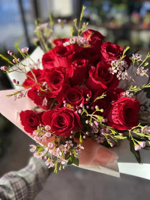Bouquet of red roses with small pink filler flowers
