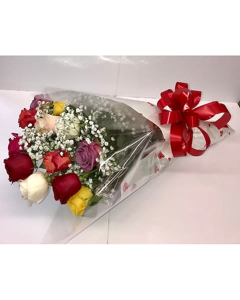 Bouquet of multicolored roses wrapped in clear plastic with a red bow