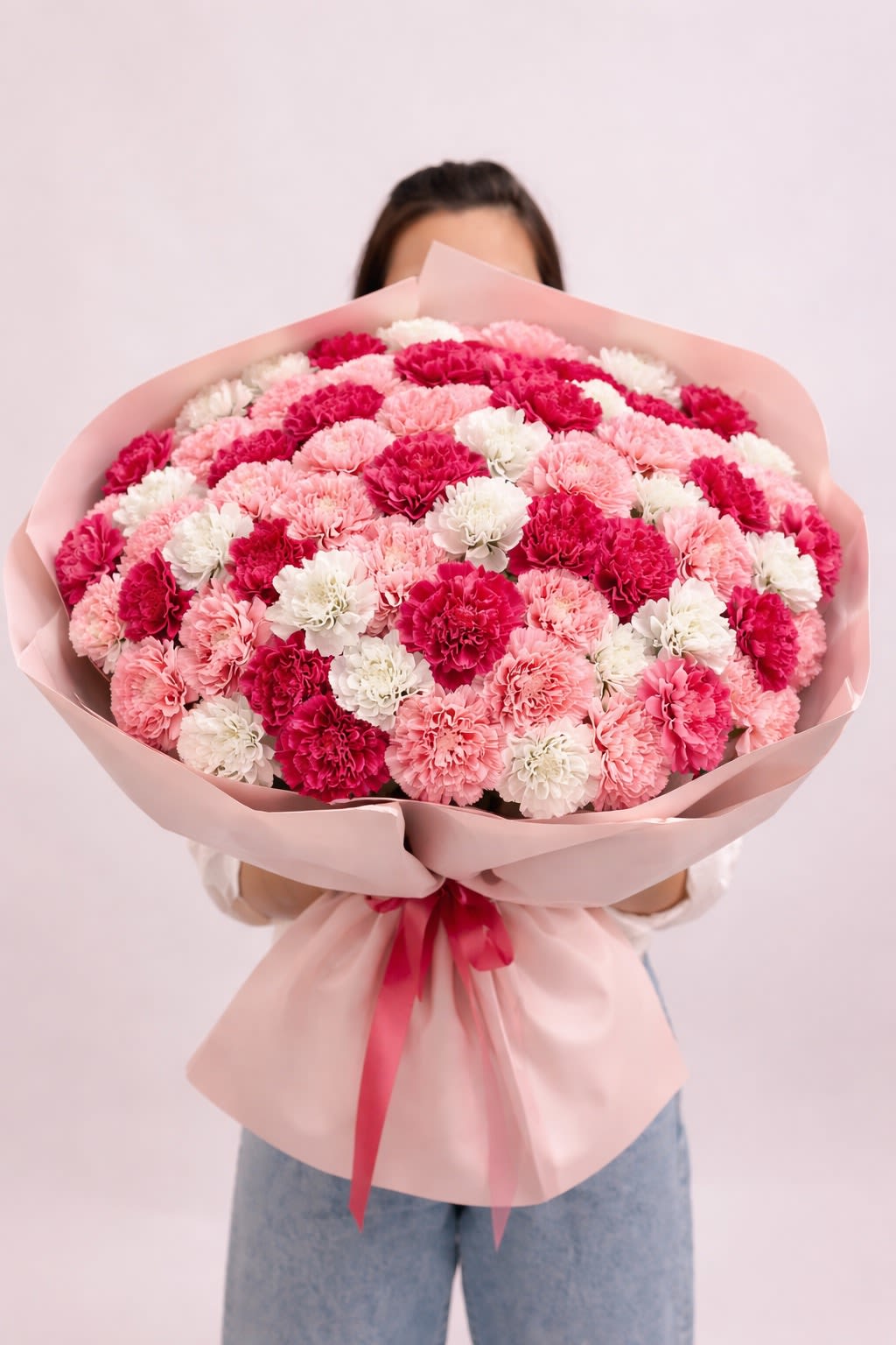 Blush Cloud - A voluminous bouquet of 110 premium carnations in soft pink, hot pink, and white tones, arranged in a full, cloud-like shape. The rich texture of the blooms creates a lush and expressive composition that feels both playful and luxurious. With its generous size and vibrant color mix, this bouquet is designed to make a bold, joyful statement—perfect for celebrations, grand gestures, and unforgettable moments