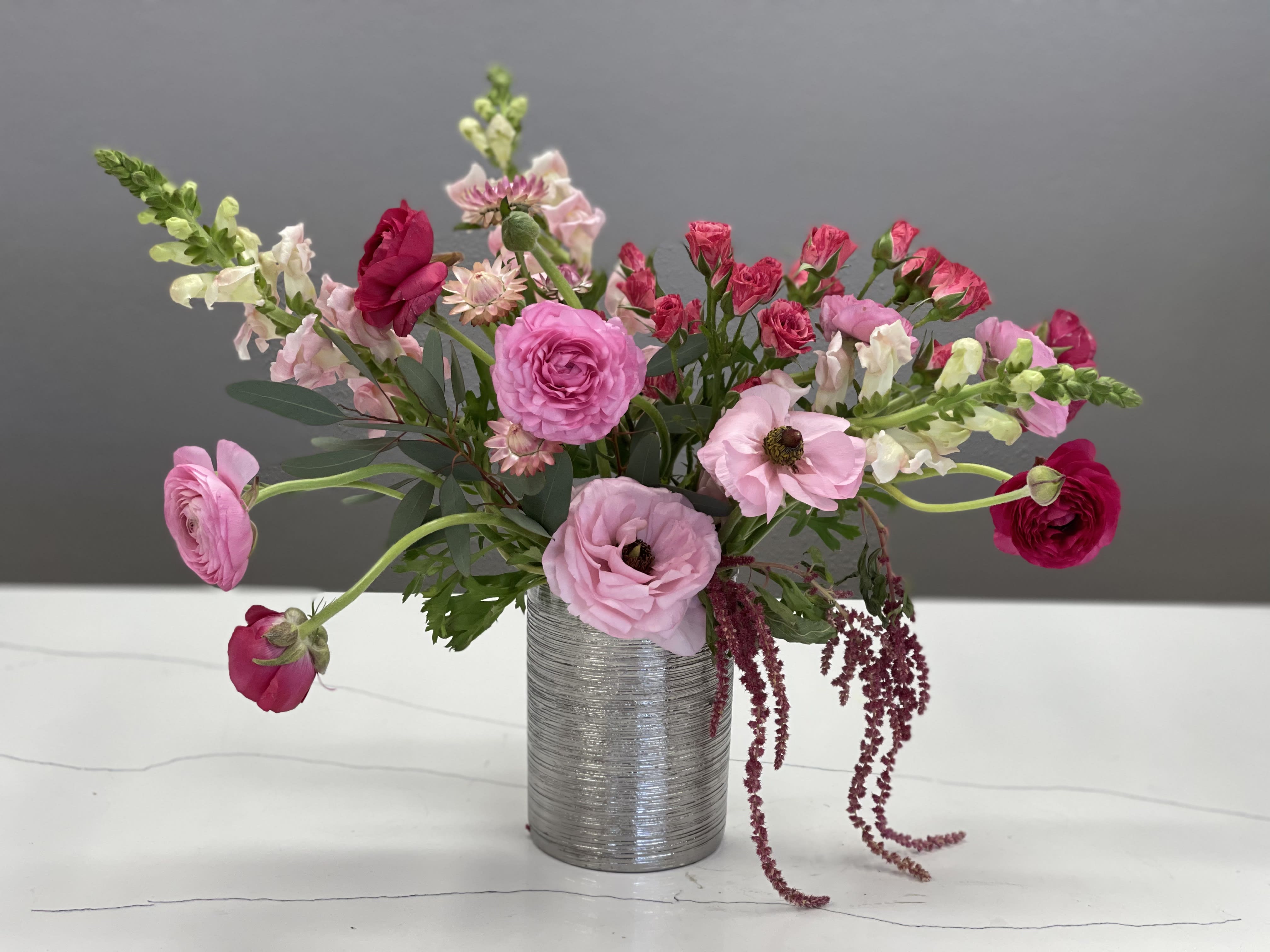 Pink and red mixed bouquet in a silver vase