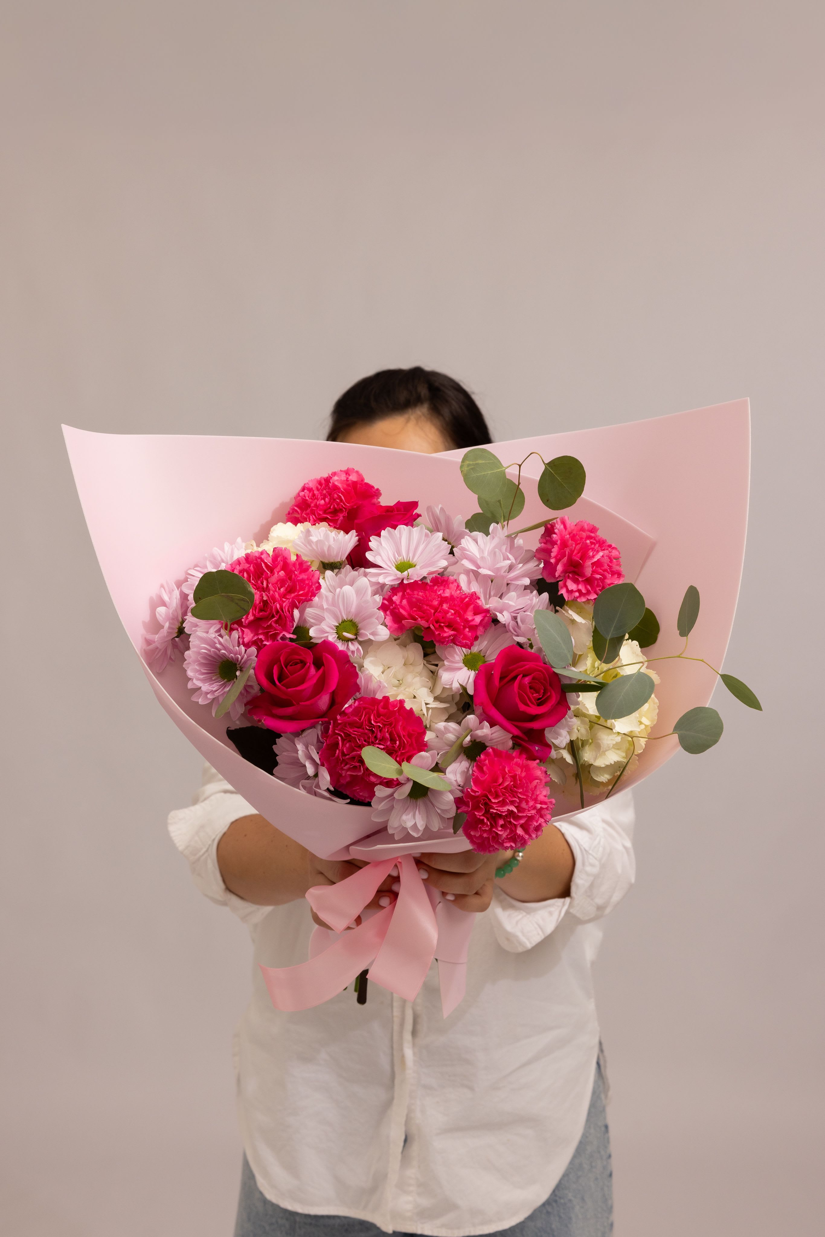 Berry Charm - A vibrant and playful bouquet in rich pink tones, featuring pink or hot pink roses, hydrangea, bright pink carnations, white and pink daisy accents, and fresh greenery. The mix of rich colors and soft textures creates a lively yet balanced composition that feels cheerful, expressive, and full of character. Designed to brighten any moment and bring a joyful, romantic energy—perfect for celebrations, surprises, and heartfelt gestures.