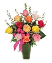 Colorful rose bouquet in a green vase with a pink ribbon
