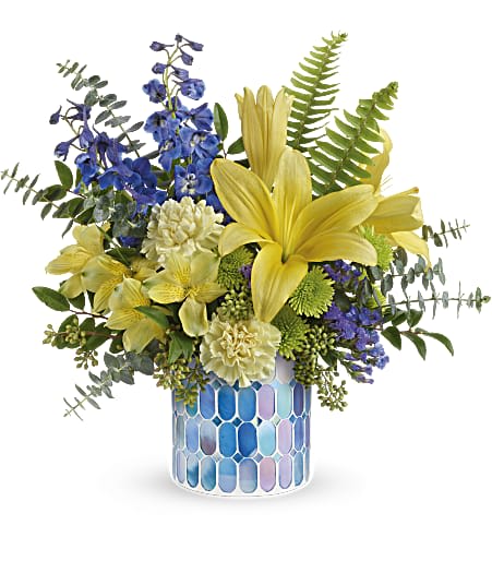 Teleflora's Seaside Sunshine Bouquet - A burst of springtime sunshine! Brighten up any day with this glorious golden bouquet, presented in a beautiful blue vase of stained glass mosaic. 