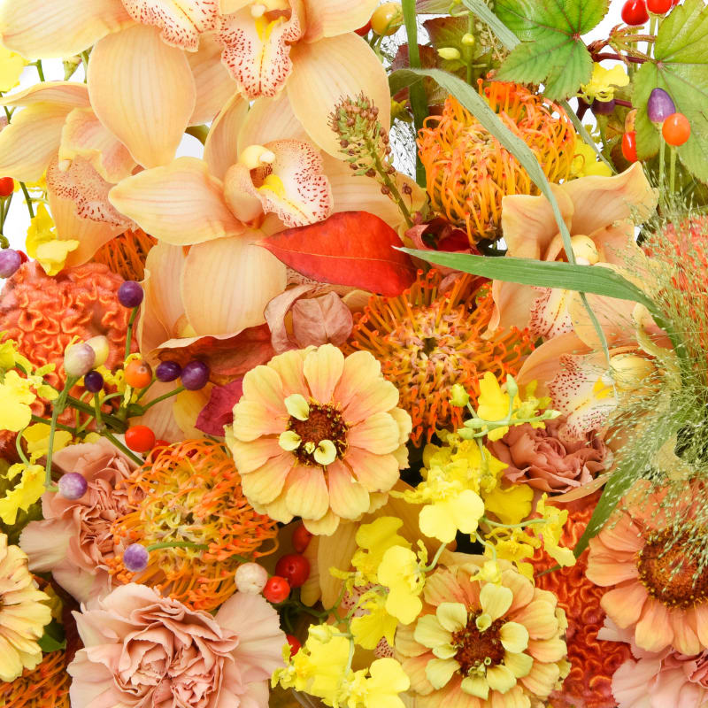 Palette No. 2   |   CITRUS BLOOM  - A warm, golden floral palette with yellow, honey, tangerine, and coral tones. Bright, cheerful, and sun-drenched.  Standard    |    *5” vase with a lush mix of seasonal blooms. Measures approximately 10" tall x 10" wide.  Deluxe    |    *6" vase with a lush mix of seasonal blooms. Measures approximately 12" tall x 12" wide.  Premium    |    *8”+ vase or other similar sized vase with a lush mix of seasonal blooms. Measures approximately 15"+ tall and wide.   *Vessels are designer choice to compliment flower selection unless specified.